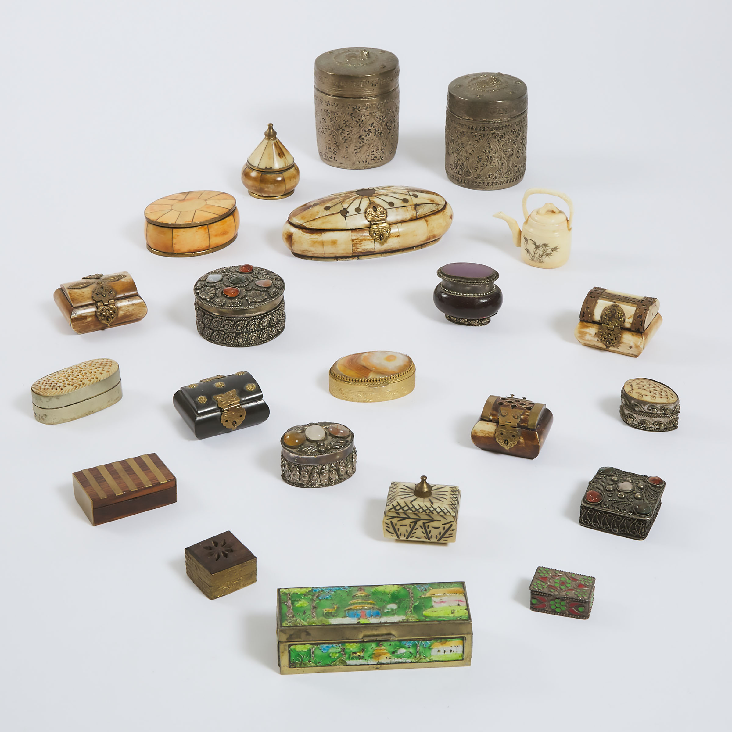 Twenty-Two Asian Boxes of Bone, Hardstone, Inset Metal and Enamel, With an Ivory Teapot