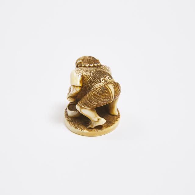 An Ivory Netsuke of an Oni Sharpening a Blade, Signed Kozan, Mid to Late 19th Century