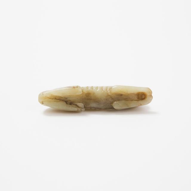 A Small Celadon and Russet Jade Recumbent Dog, Ming Dynasty, 17th/18th Century