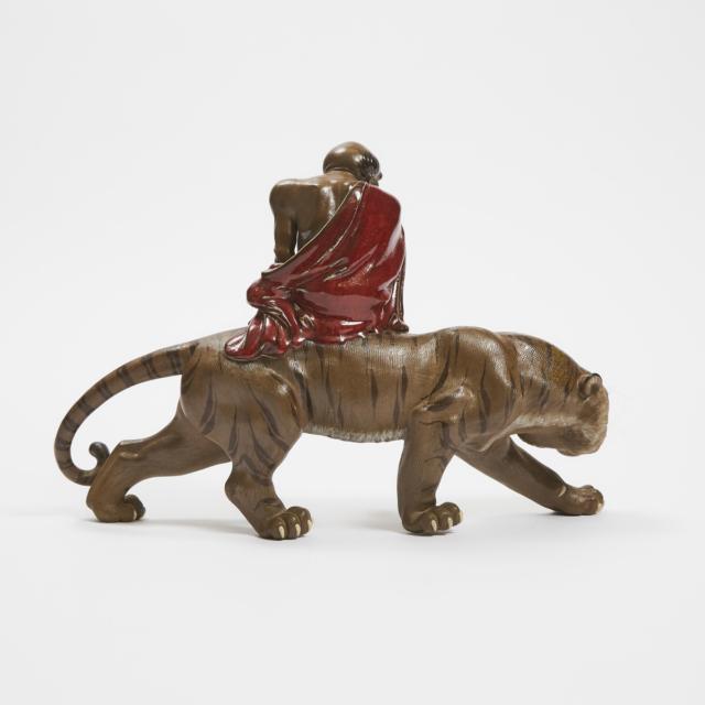 A Shiwan Figure of a Luohan Riding a Tiger