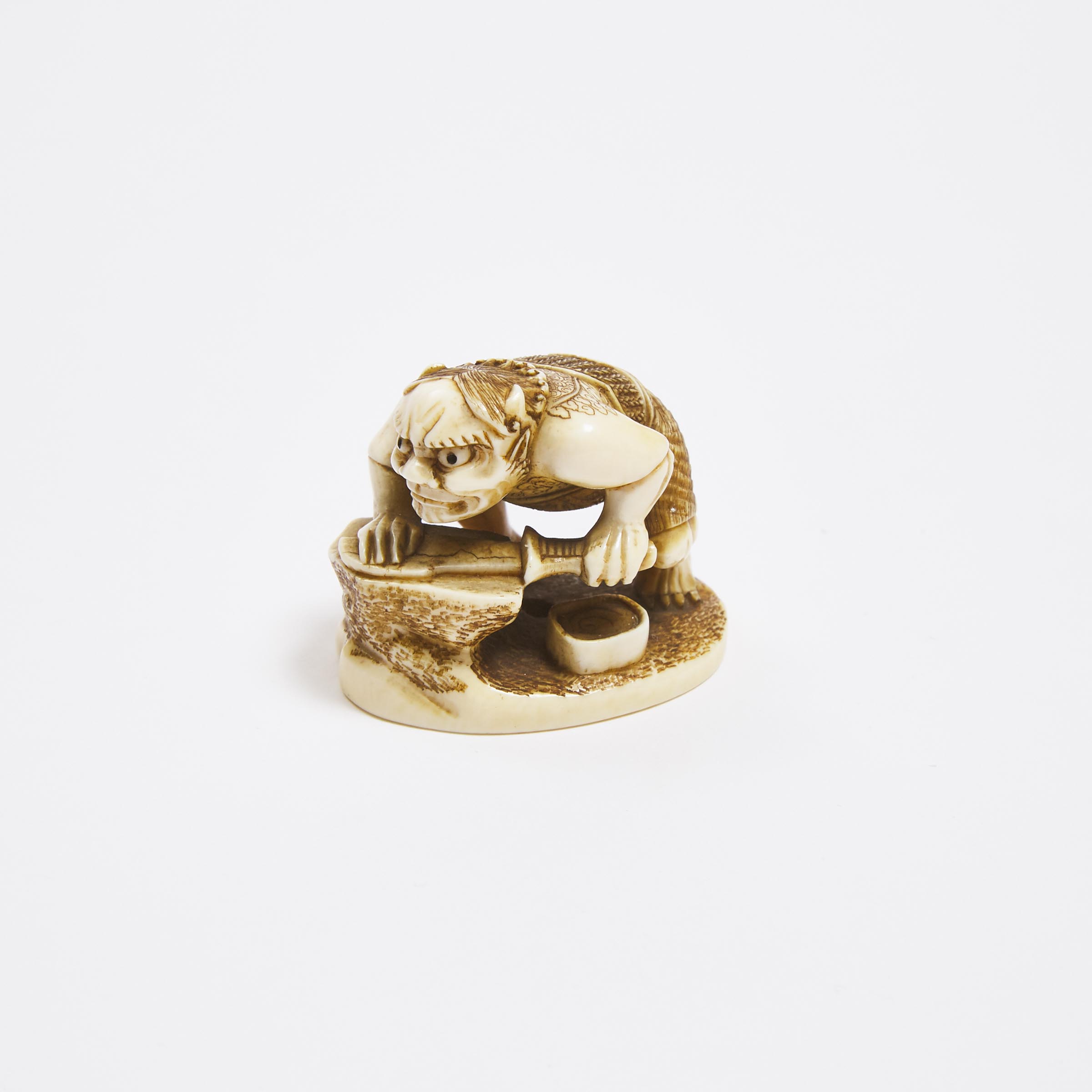 An Ivory Netsuke of an Oni Sharpening a Blade, Signed Kozan, Mid to Late 19th Century