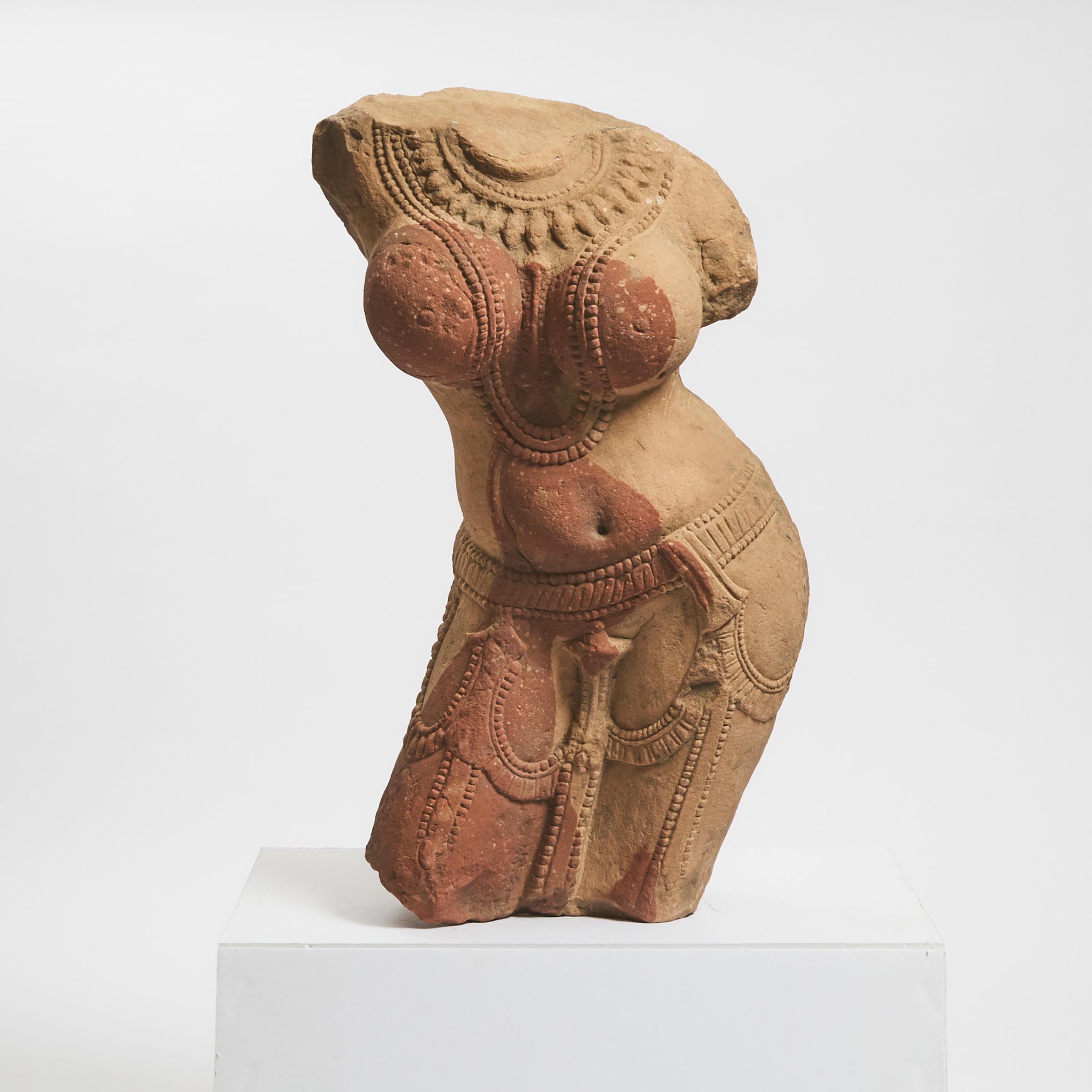 A Large Mottled Red Sandstone Torso of a Female Deity, India, 12th Century or Later