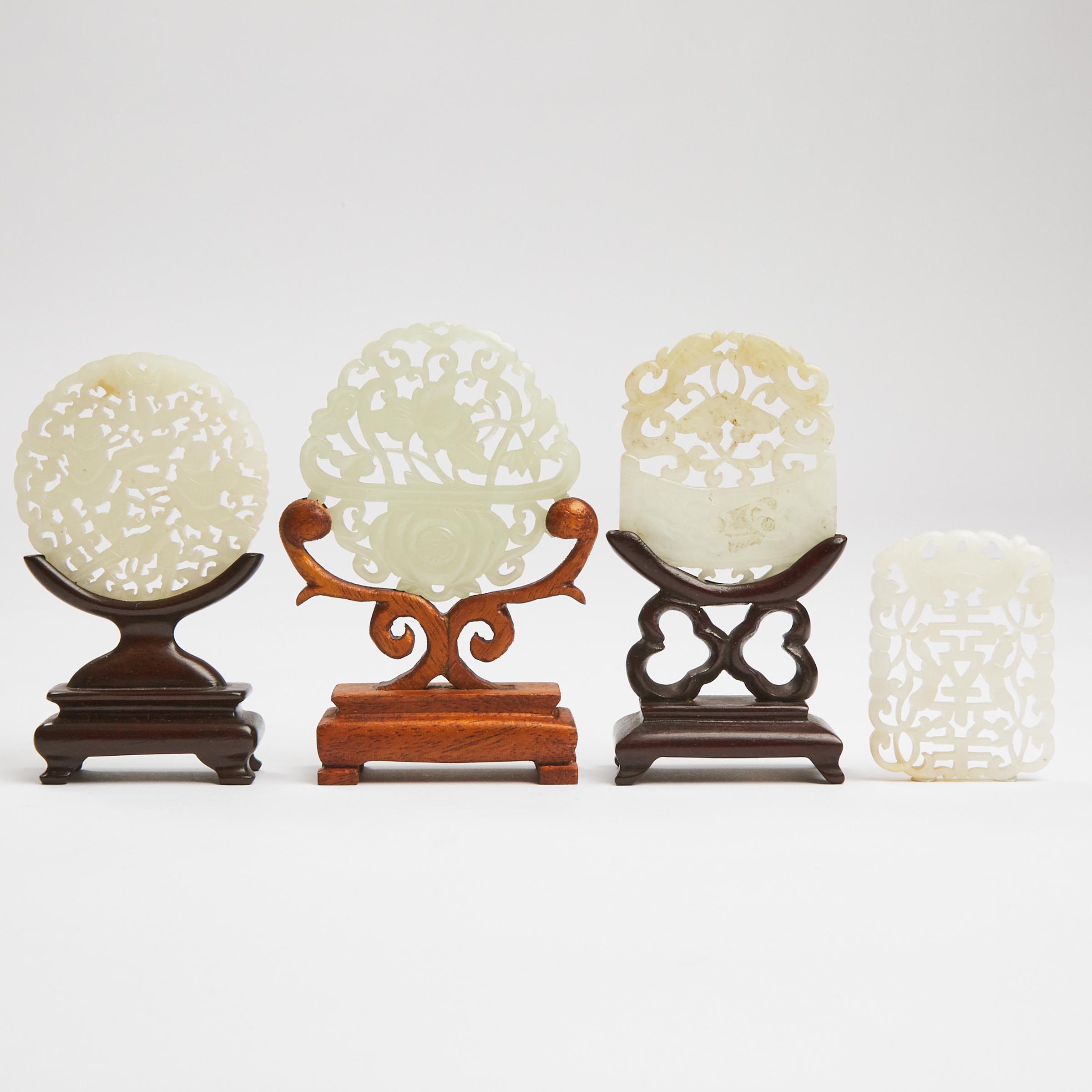 A Group of Four Carved and Pierced White Jade Plaques, Ming/Qing Dynasty