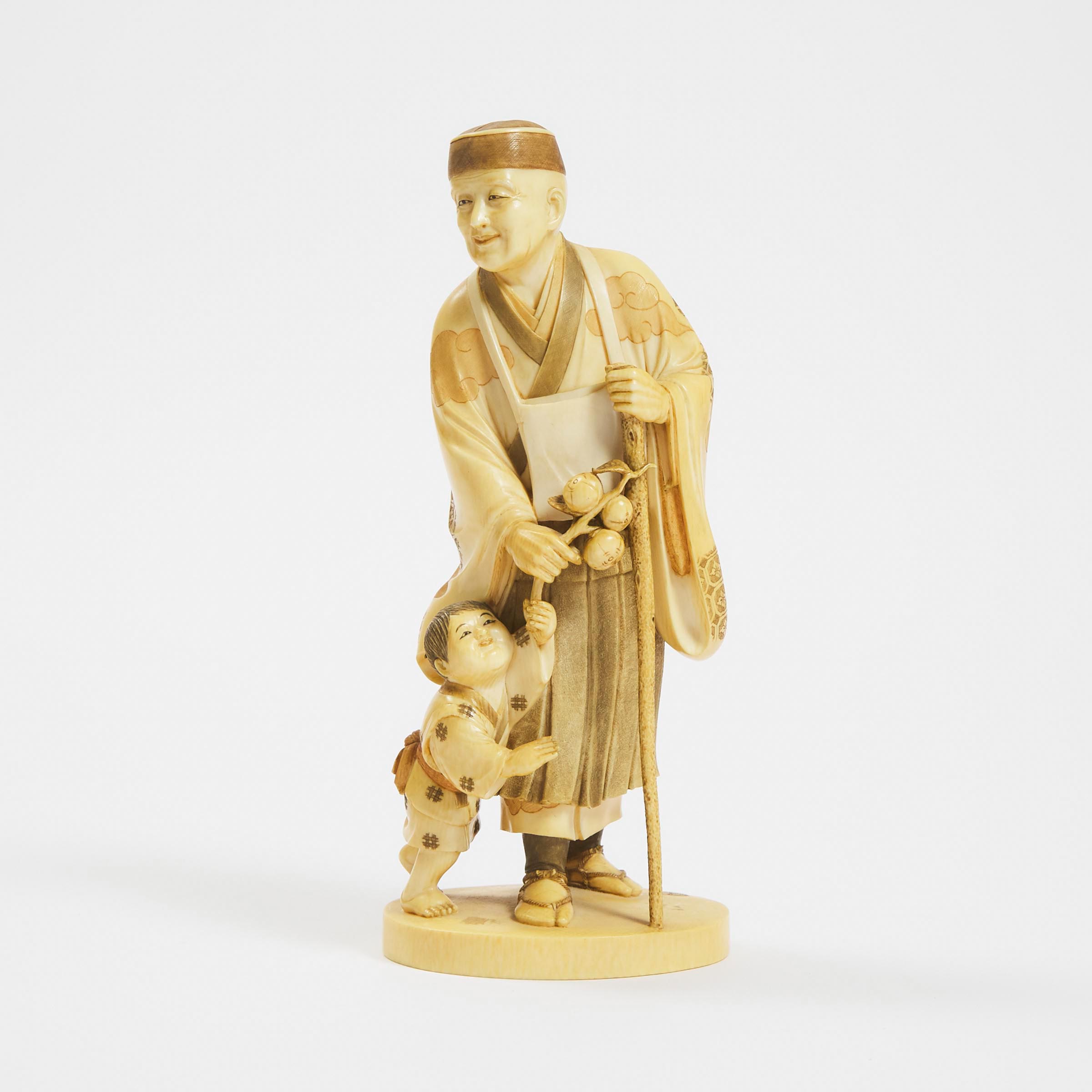 A Tinted Ivory Okimono of a Monk and a Child, Signed Kozan, Meiji Period