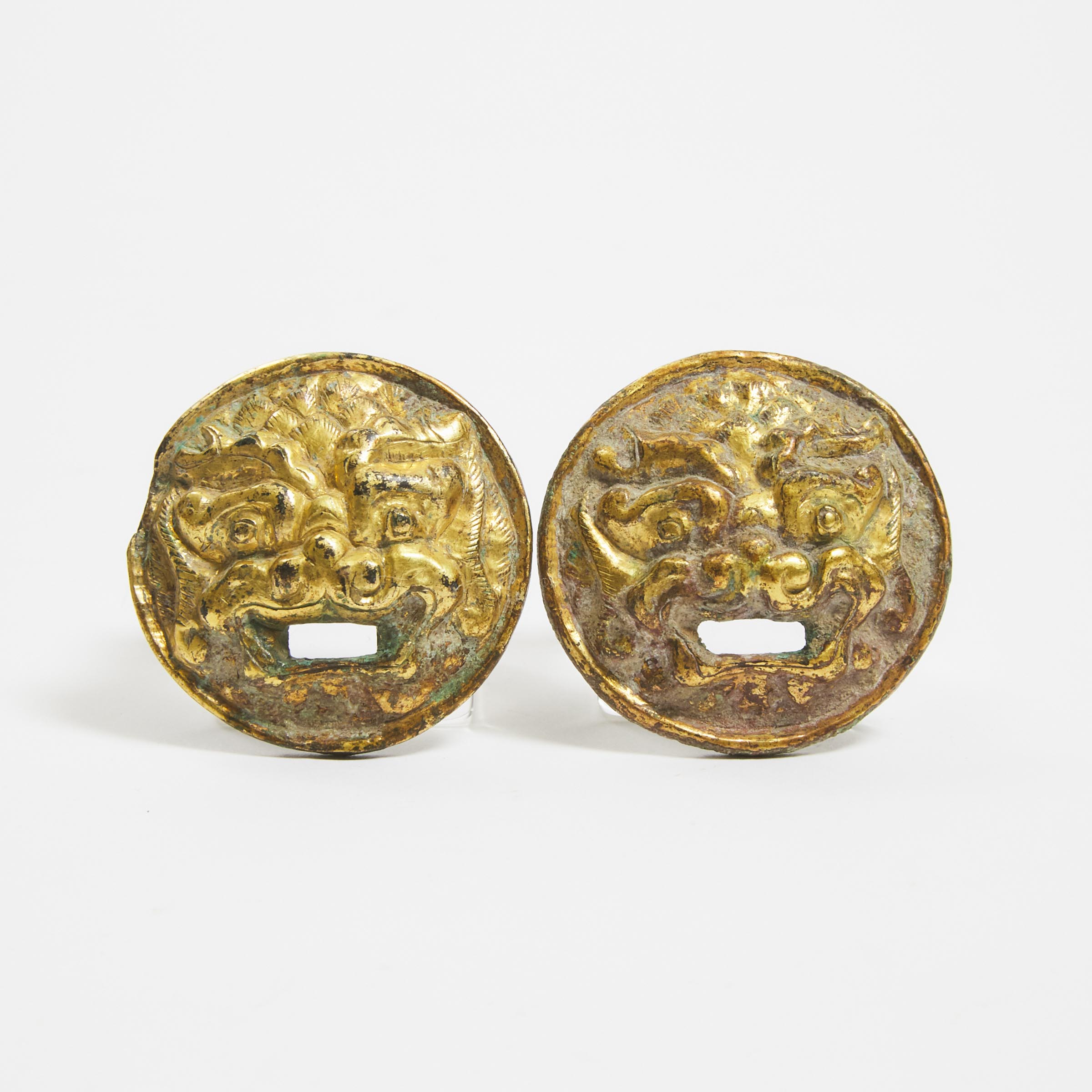 A Pair of Gilt Bronze 'Mythical Beast' Roundels, Tang Dynasty (AD 618-907)