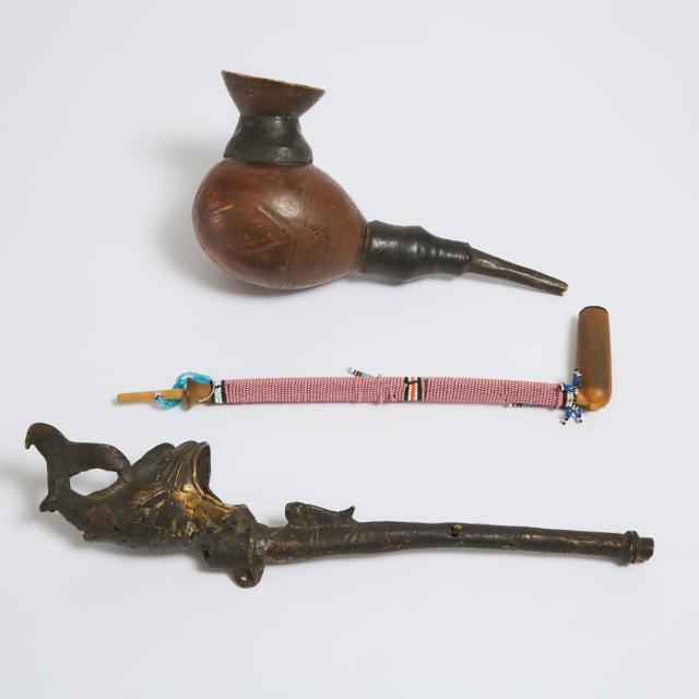 Two African Pipes together with a Decorative Pipe, 20th century