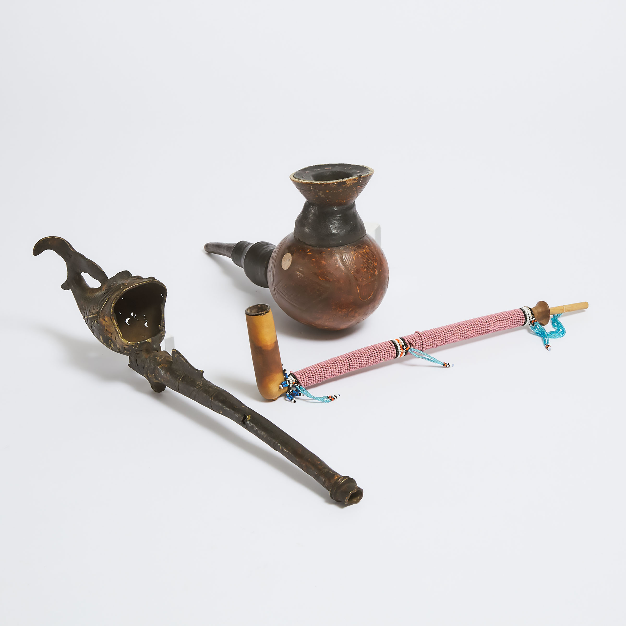 Two African Pipes together with a Decorative Pipe, 20th century