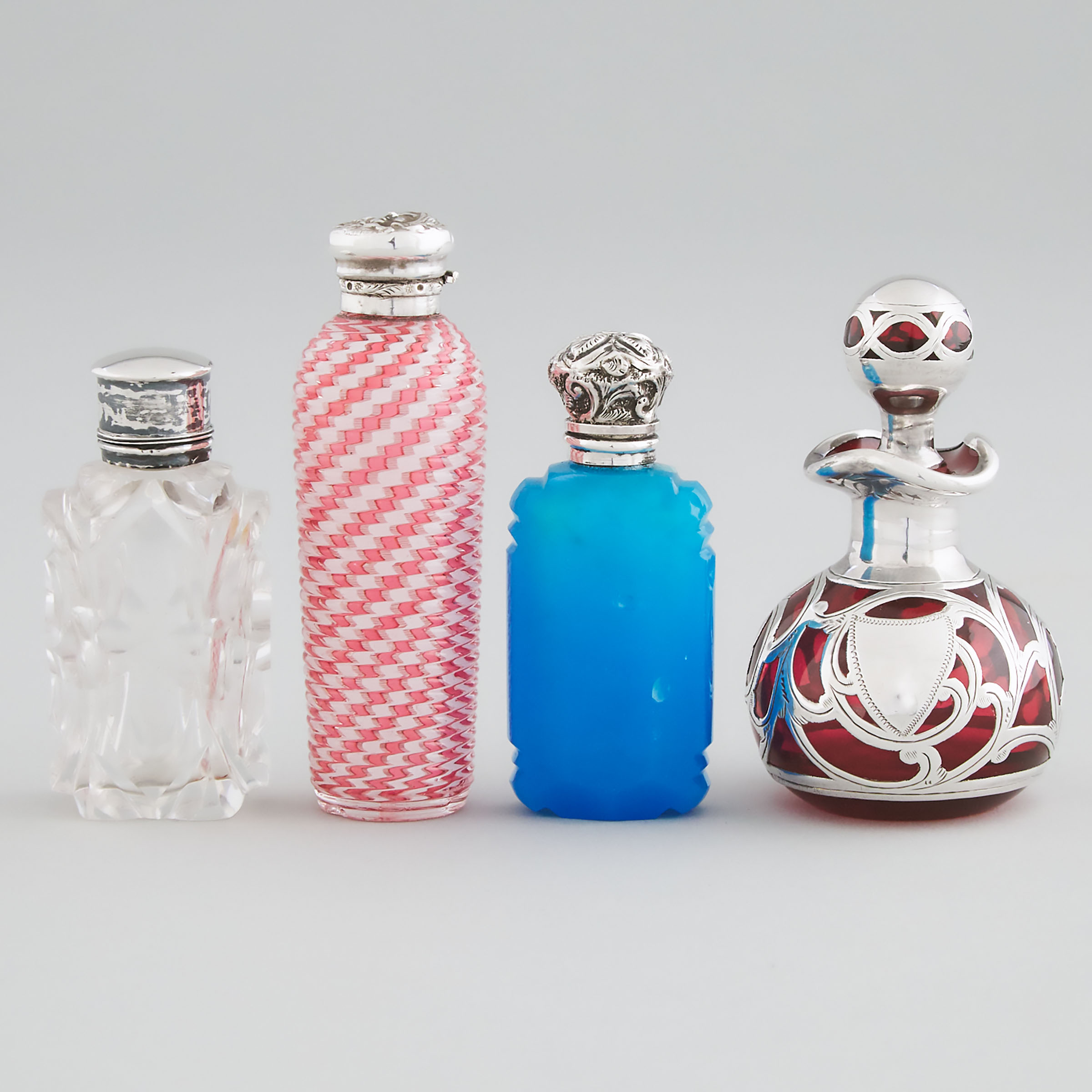 Four Silver Mounted or Overlaid Glass Perfume Bottles, 19th/20th century