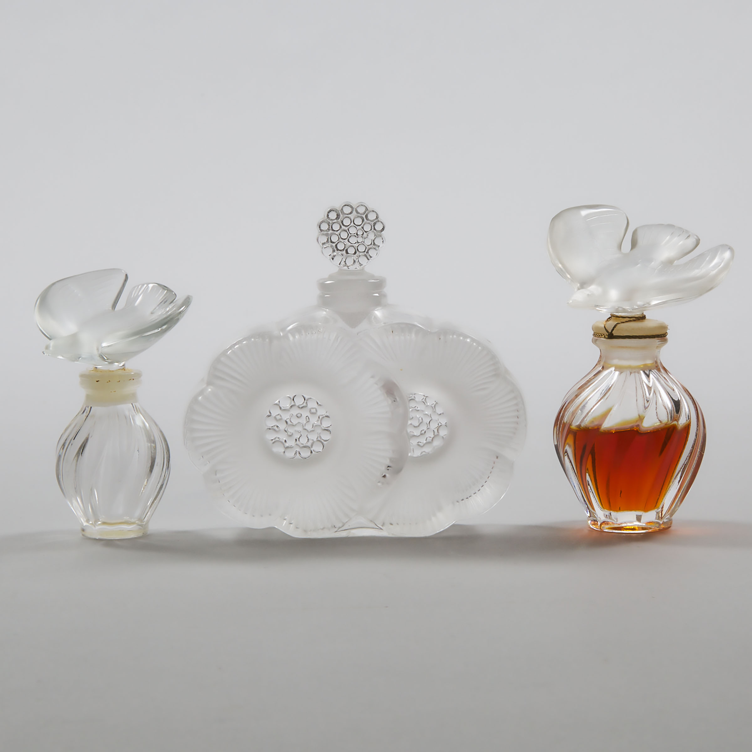 'Deux Fleurs', Lalique Moulded and Partly Frosted Glass Perfume Bottle and Two Others, 20th century
