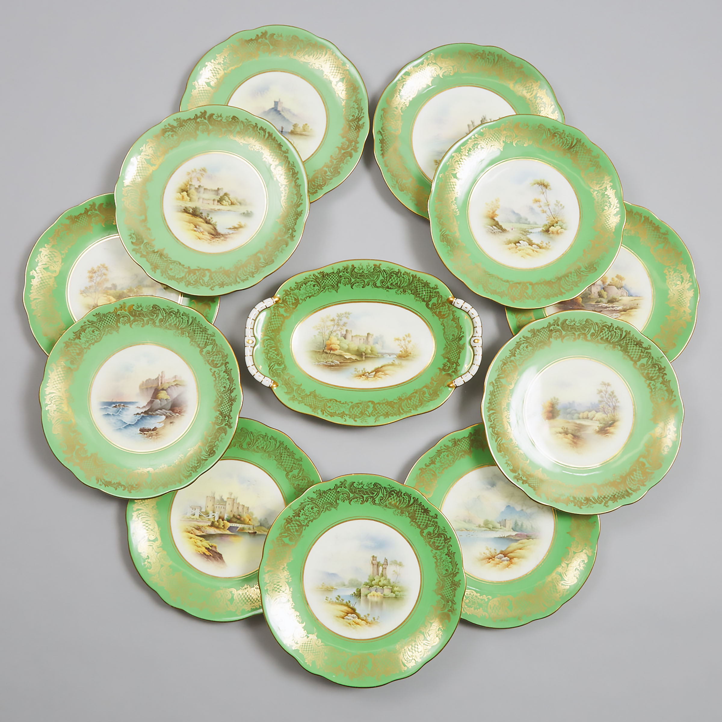 Eleven Coalport Apple Green Ground Topographical Dessert Plates and a Serving Dish, Percy Simpson, early 20th century