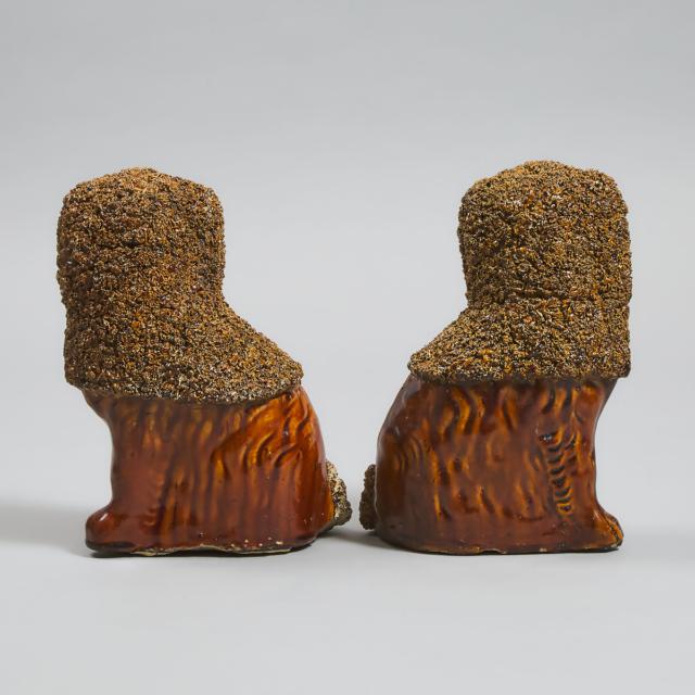 Pair of American 'Rockingham' Treacle Glazed Figures of Seated Spaniels, 19th century 