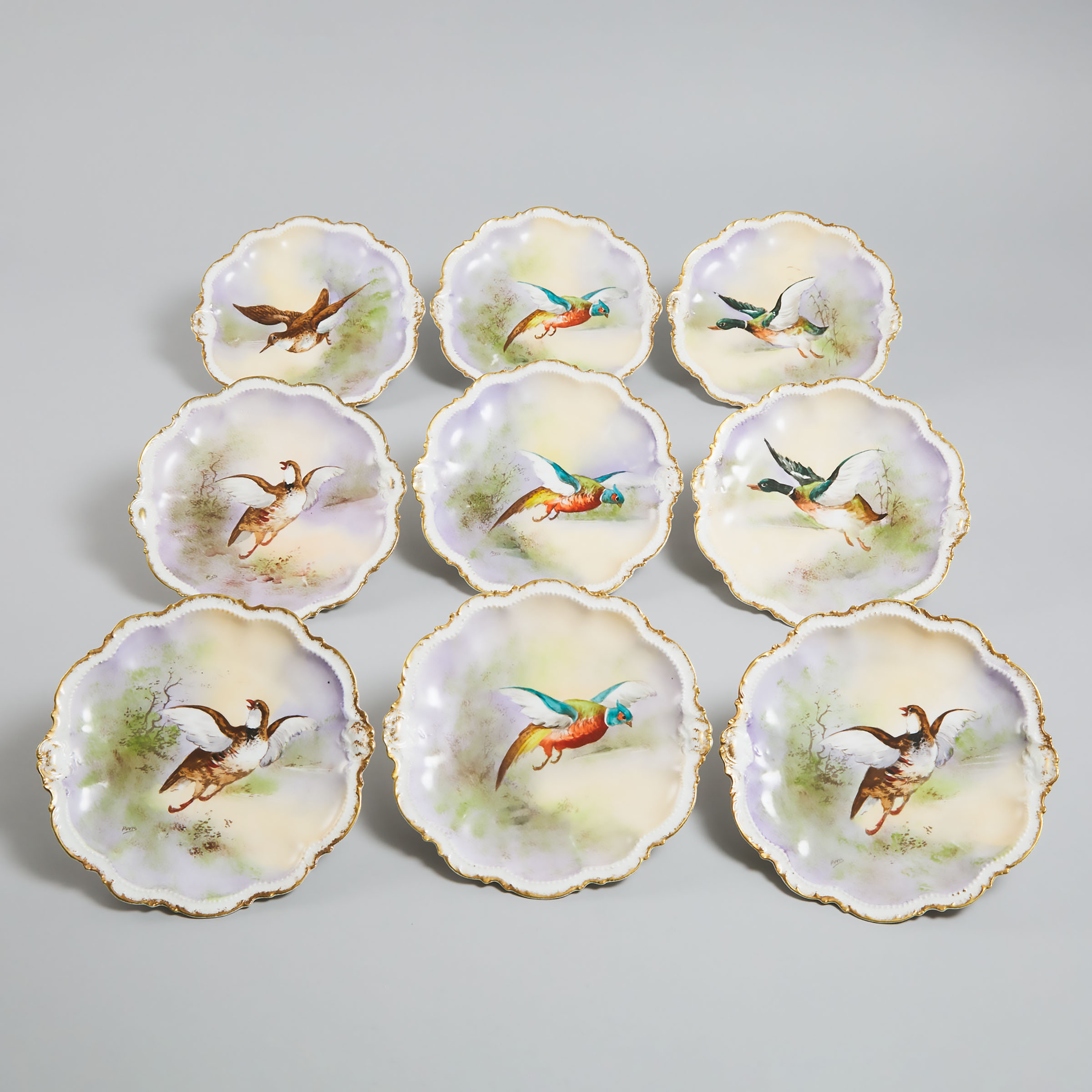 Nine Limoges Game Plates, early 20th century