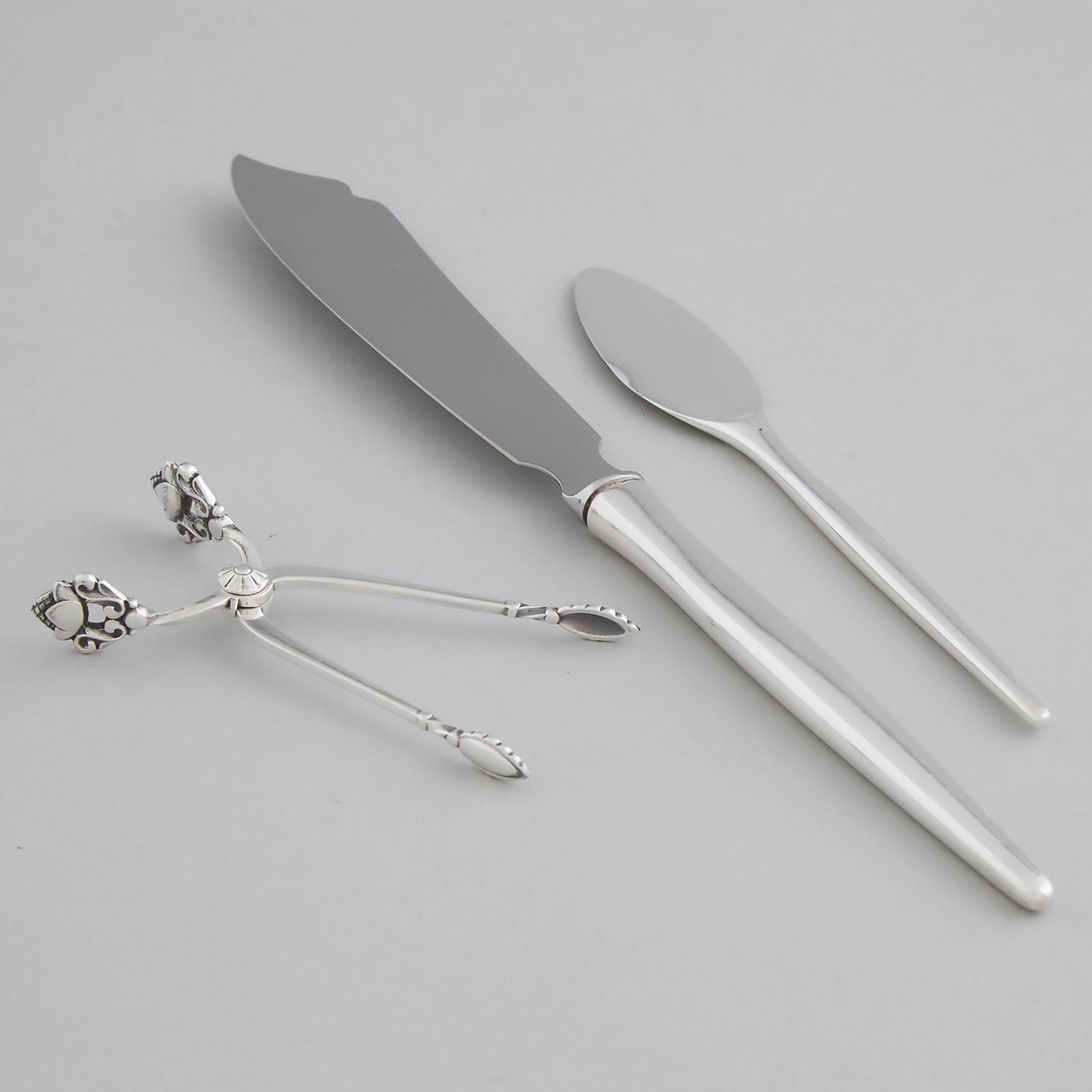 Danish Silver ‘Acorn’ Pattern Sugar Tongs, Georg Jensen, and Two Knives, Anton Michelsen, Copenhagen, 20th century
