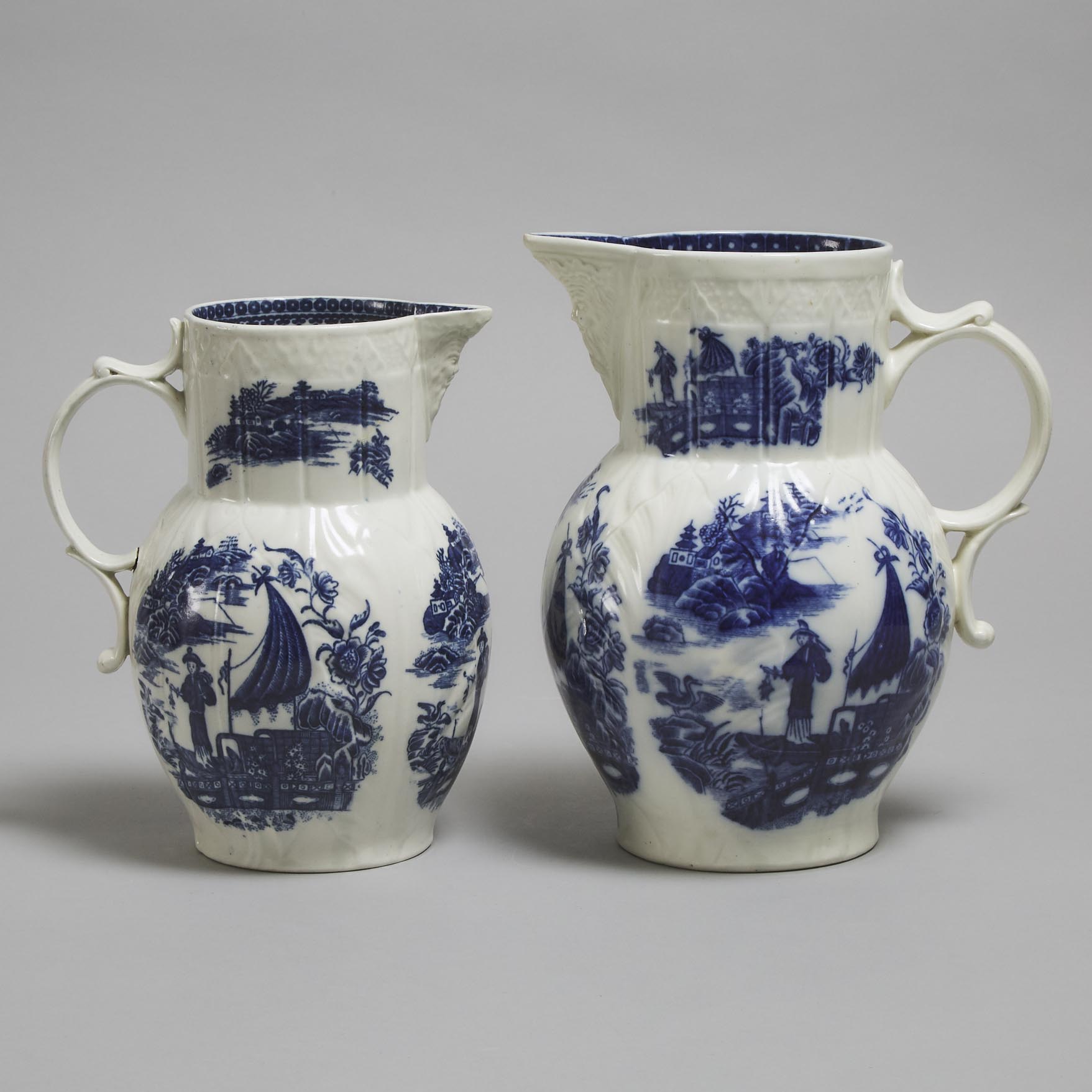 Two Caughley 'Fisherman' Moulded Cabbage Leaf and Mask Jugs, c.1780-90