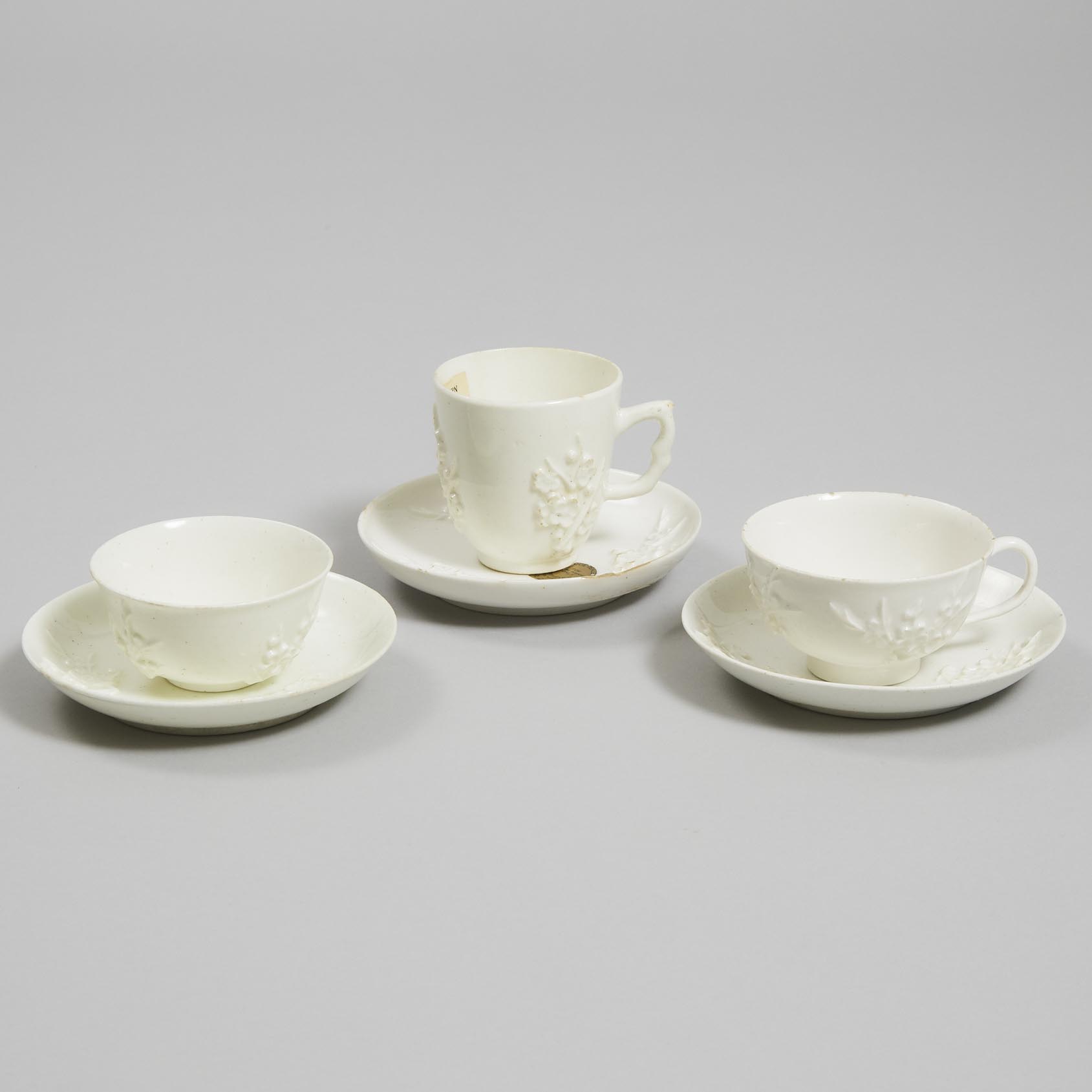 Two Bow Moulded and White Glazed Prunus Cups and a Tea Bowl and Three Saucers, c.1752-55