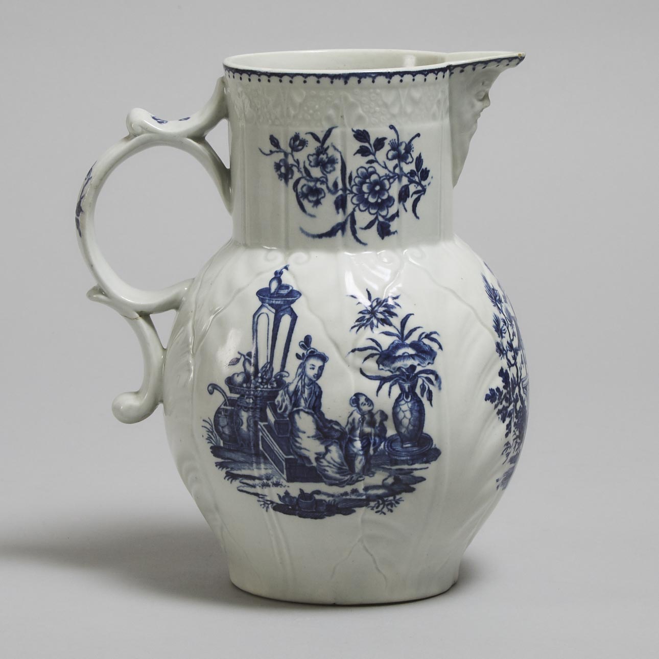 Worcester Blue Printed 'Mother and Child' and 'Temple Bells' Cabbage Leaf and Mask Jug, c.1775