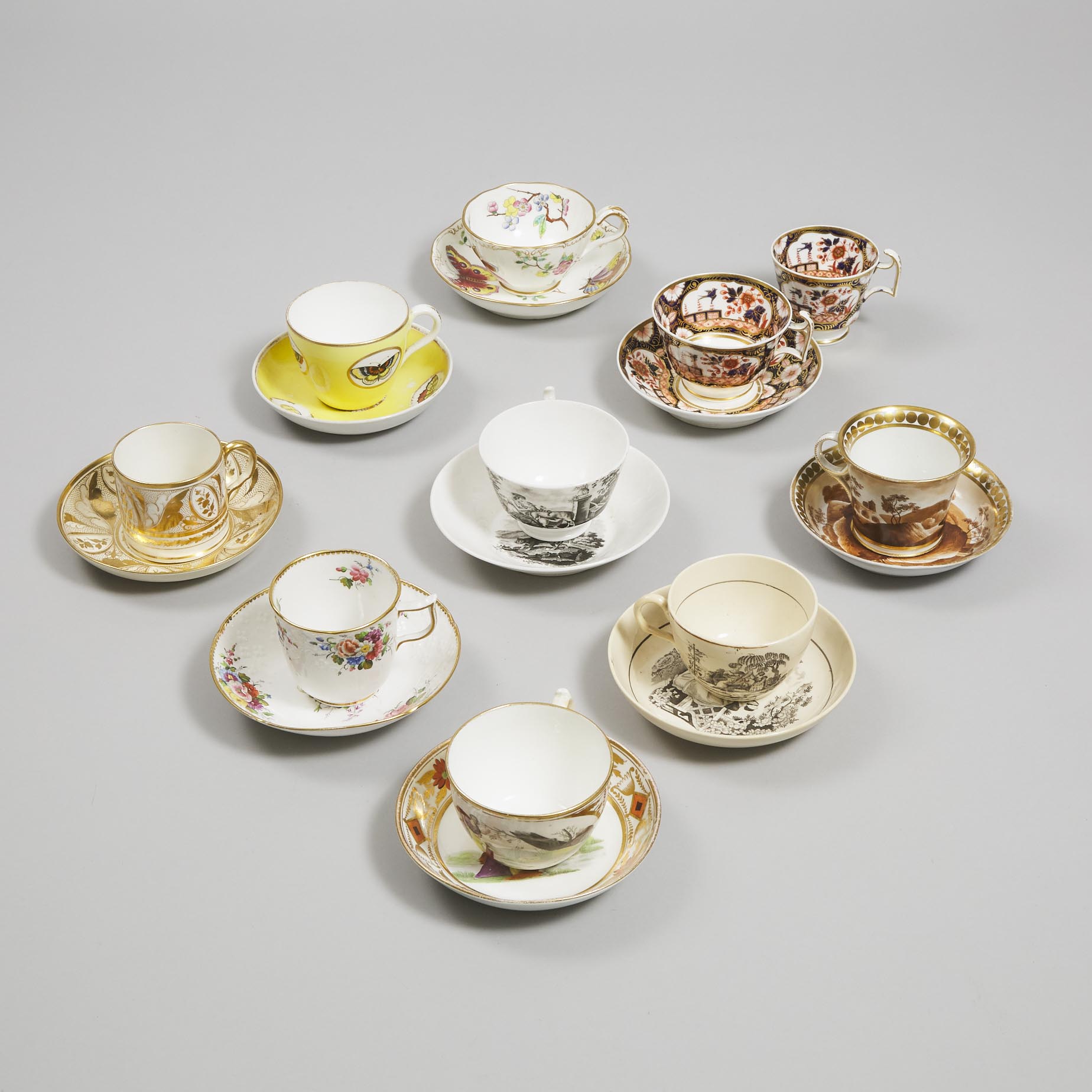 Eight English Porcelain Cups and Saucers and a Trio, early 19th century