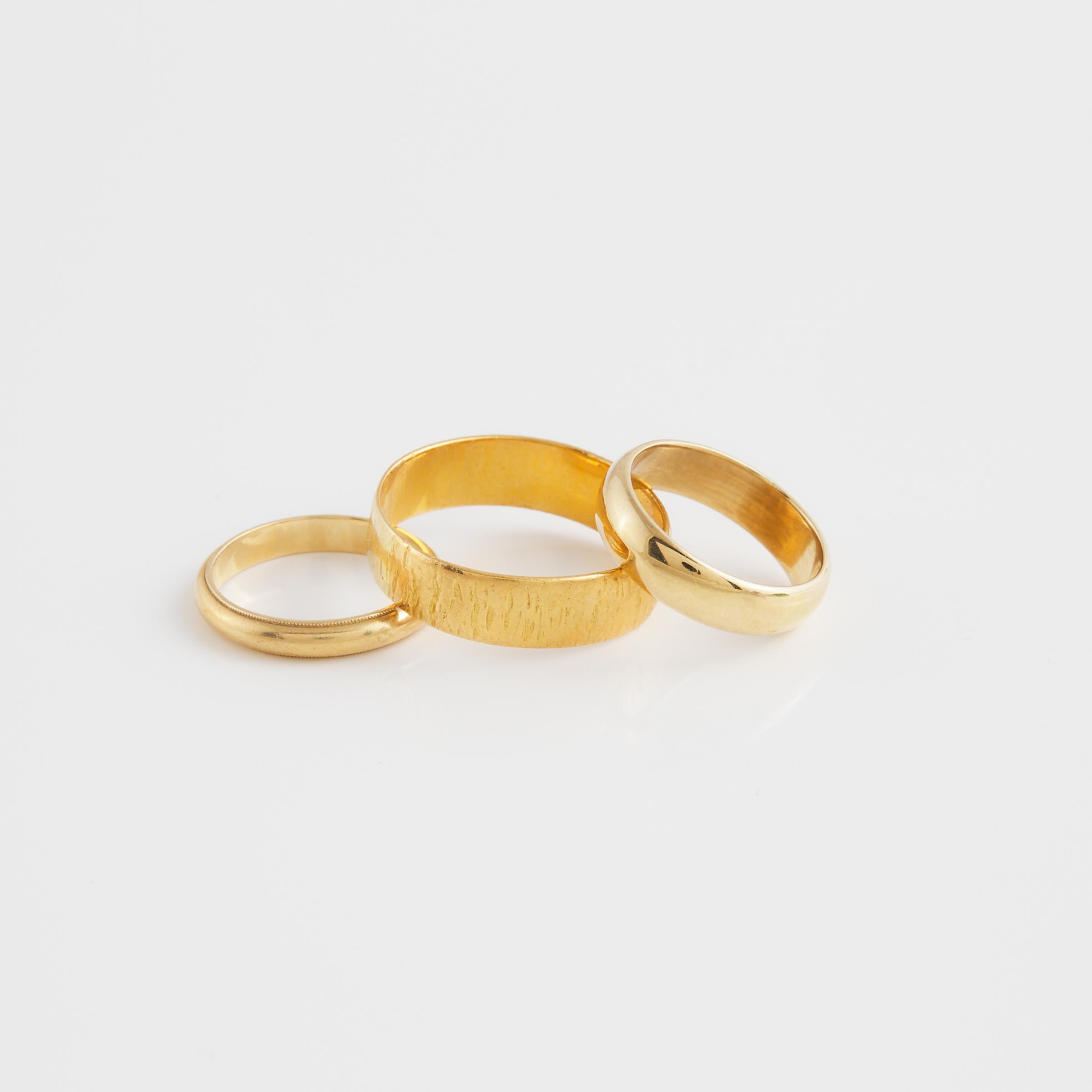 An English 22k And 2 x 14k Yellow Gold Bands 