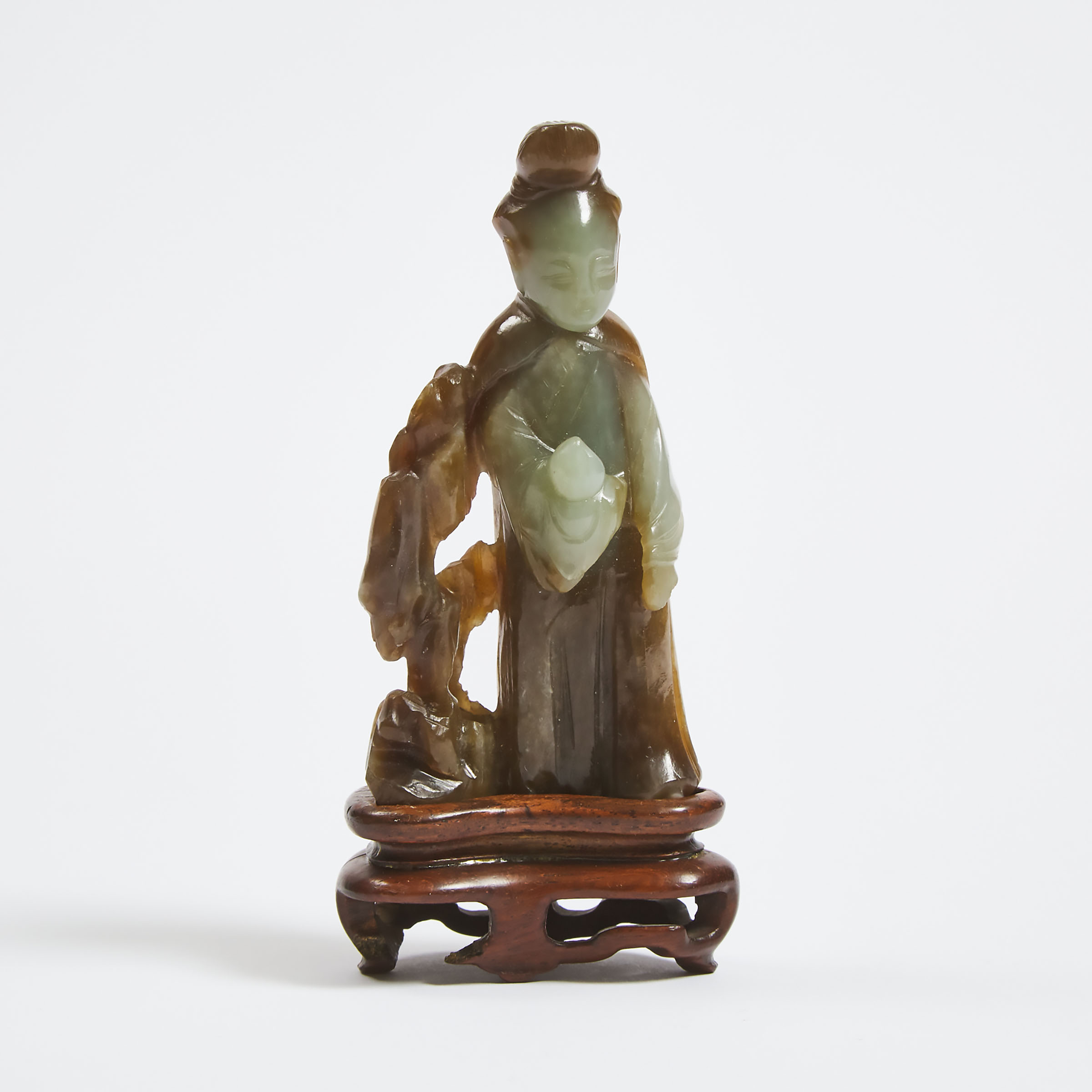 A Celadon and Russet Jade Figure of Magu, Late Ming/Early Qing Dynasty, 17th/18th Century