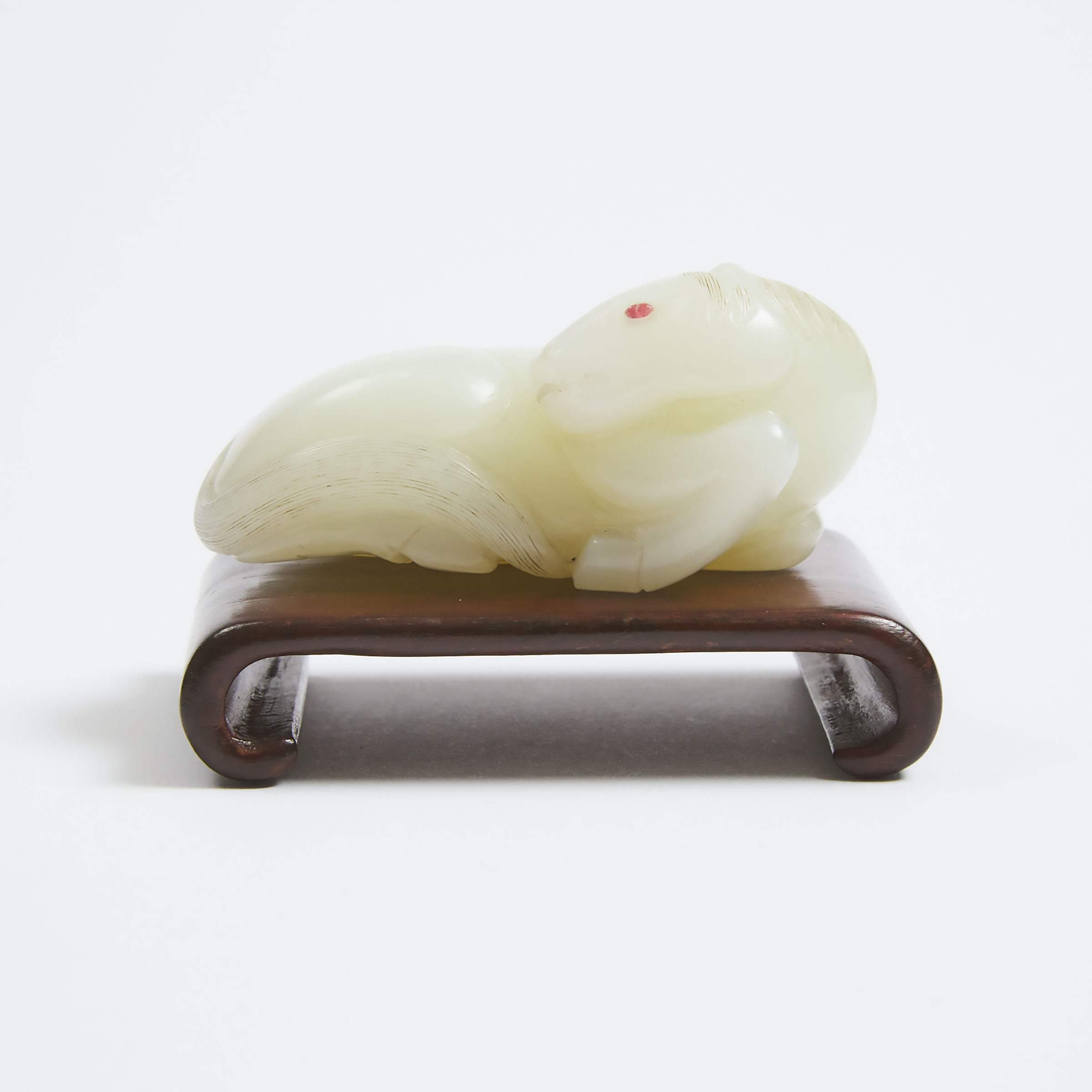 An Exceptional and Finely Carved White Jade Recumbent Horse, Qing Dynasty, Qianlong Period (1736-1795)