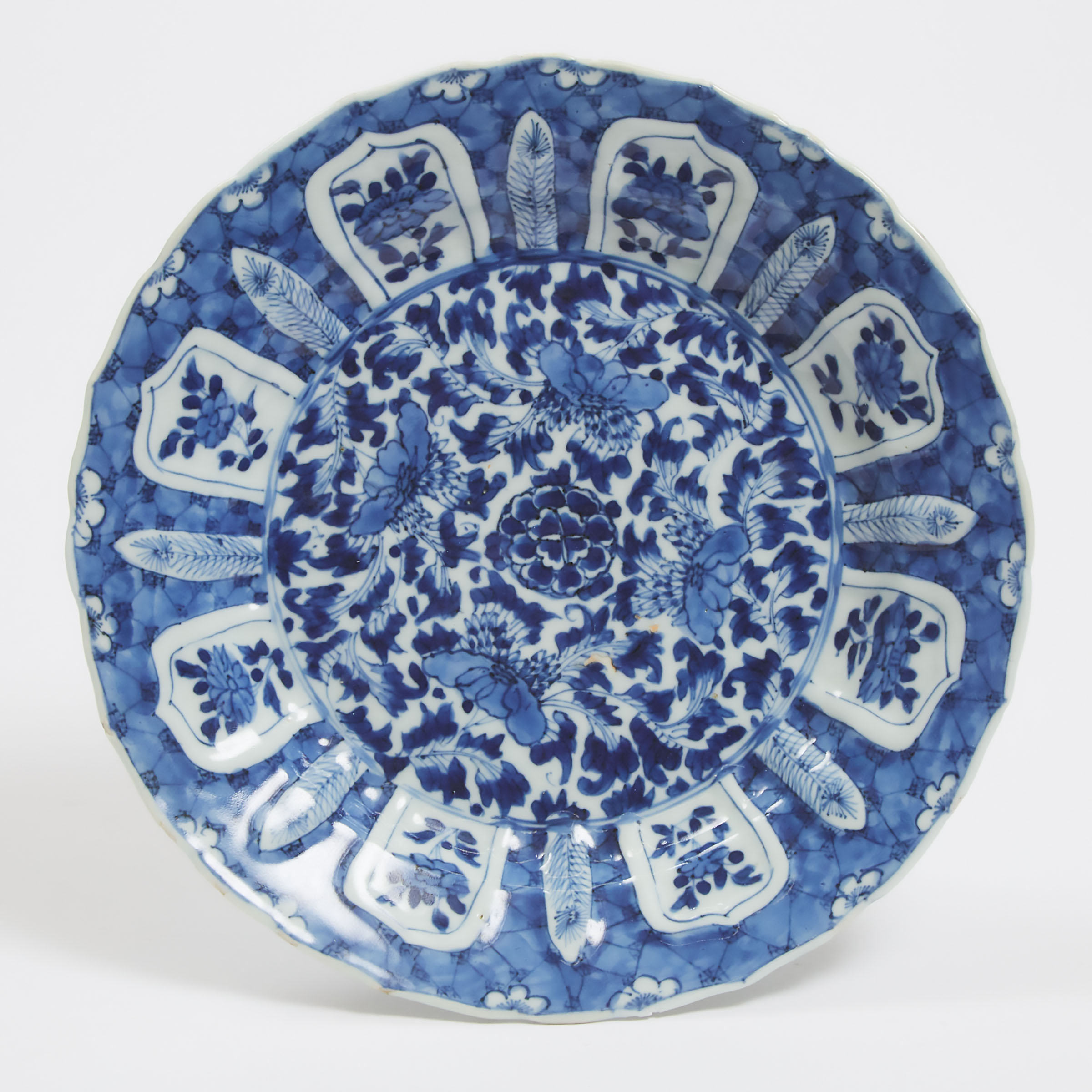 A Moulded Blue and White Barbed-Rim Dish, Kangxi Period (1662-1722)