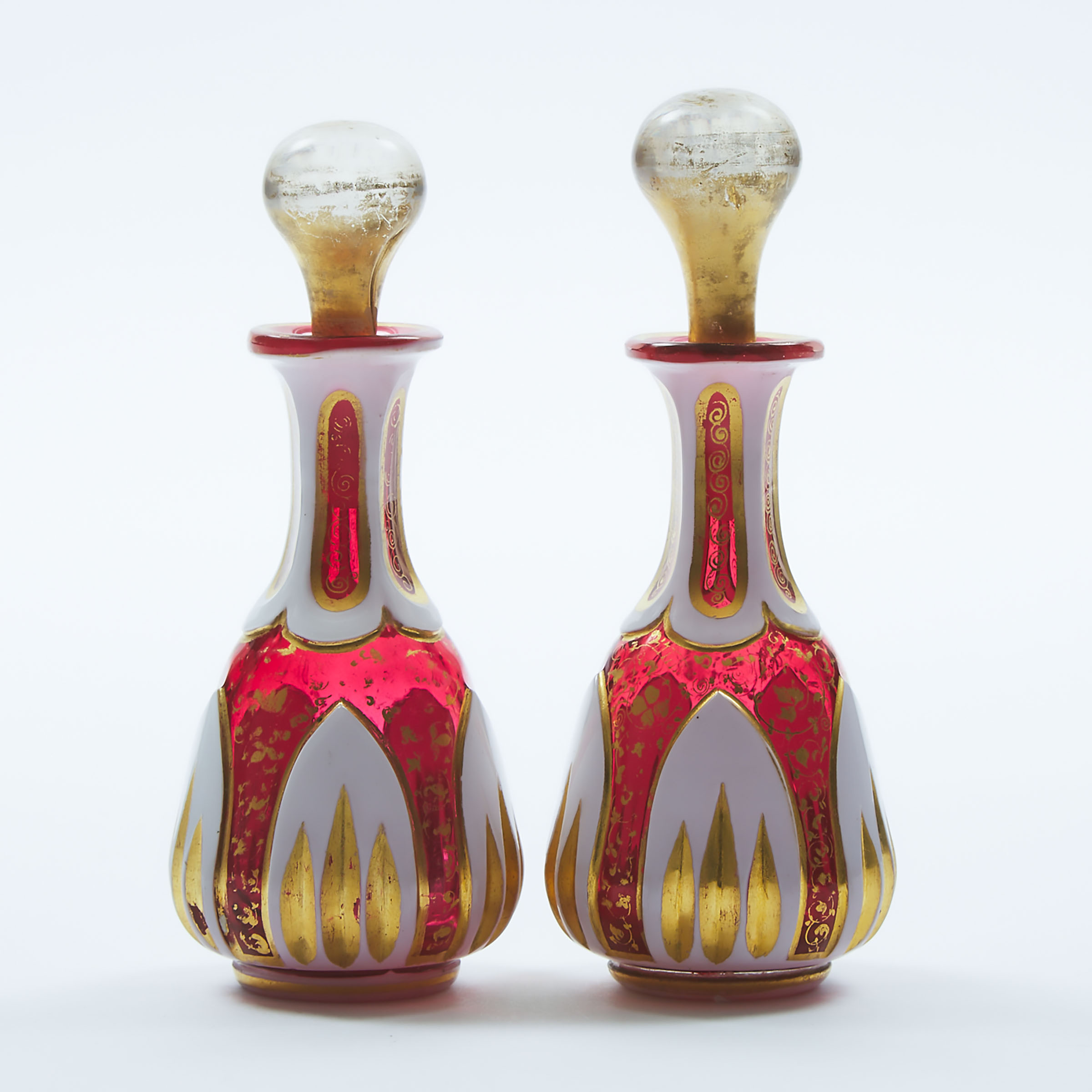 Pair of Bohemian Overlaid, Cut and Gilt Red Glass Perfume Bottles, late 19th century