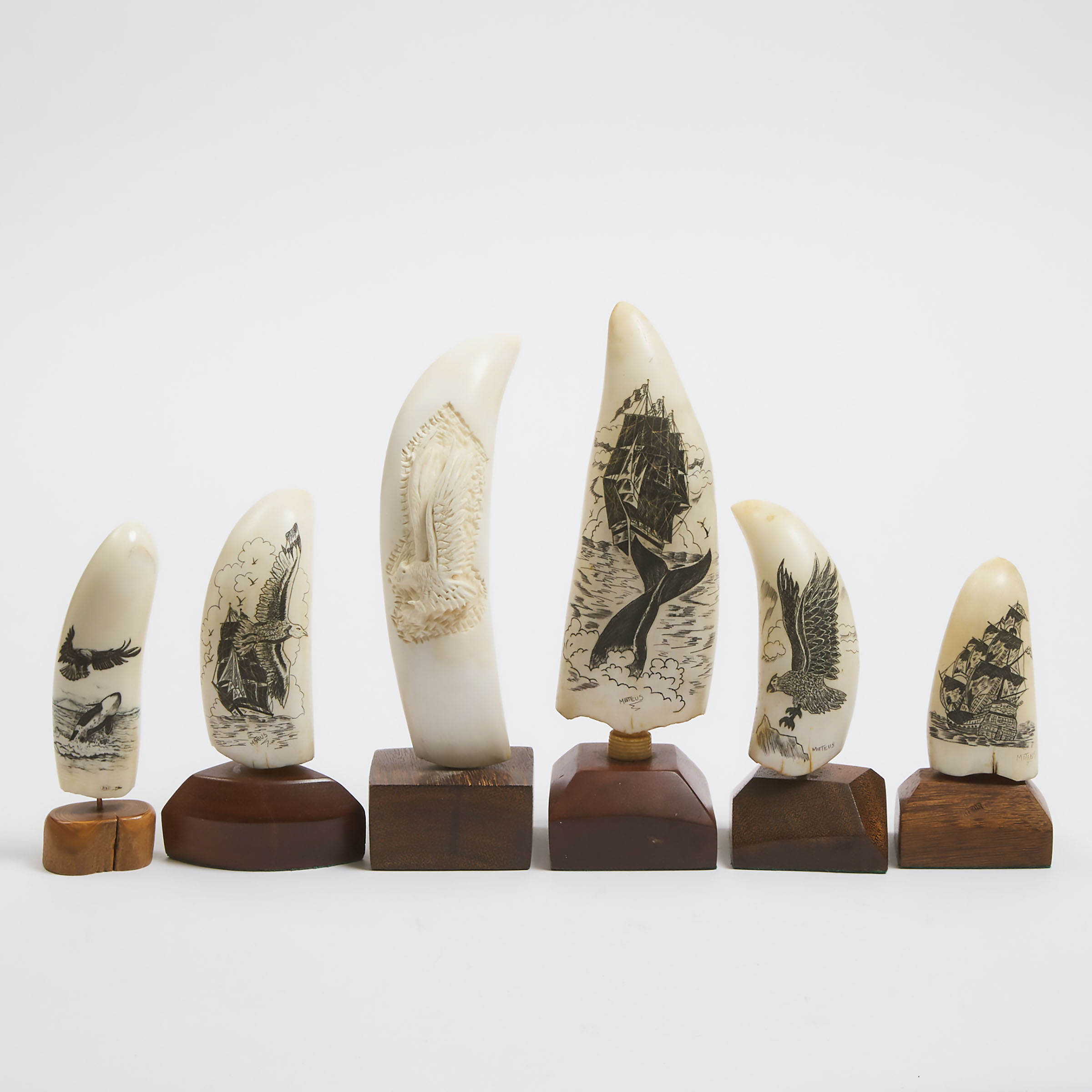 Six Scrimshawed or Carved Whale Teeth, late 20th century