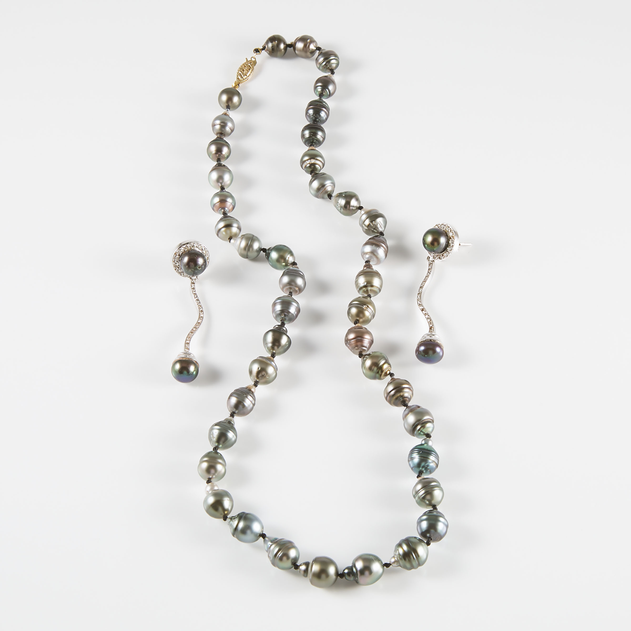 A Pair Of 18k White Gold Drop Earrings And A Single Strand Of Ringed Grey Pearls