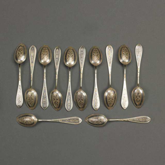 Twelve Russian Nielloed Silver-Gilt Tea Spoons, Moscow, 1870/78