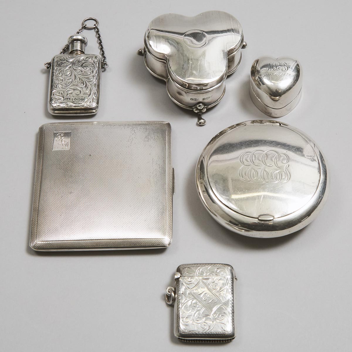 Edwardian and Later English Silver Cigarette Case, Tobacco Box, Heart-Shaped Box, Vesta Case, Jewellery Box and a Perfume Phial, Birmingham, 1902-57