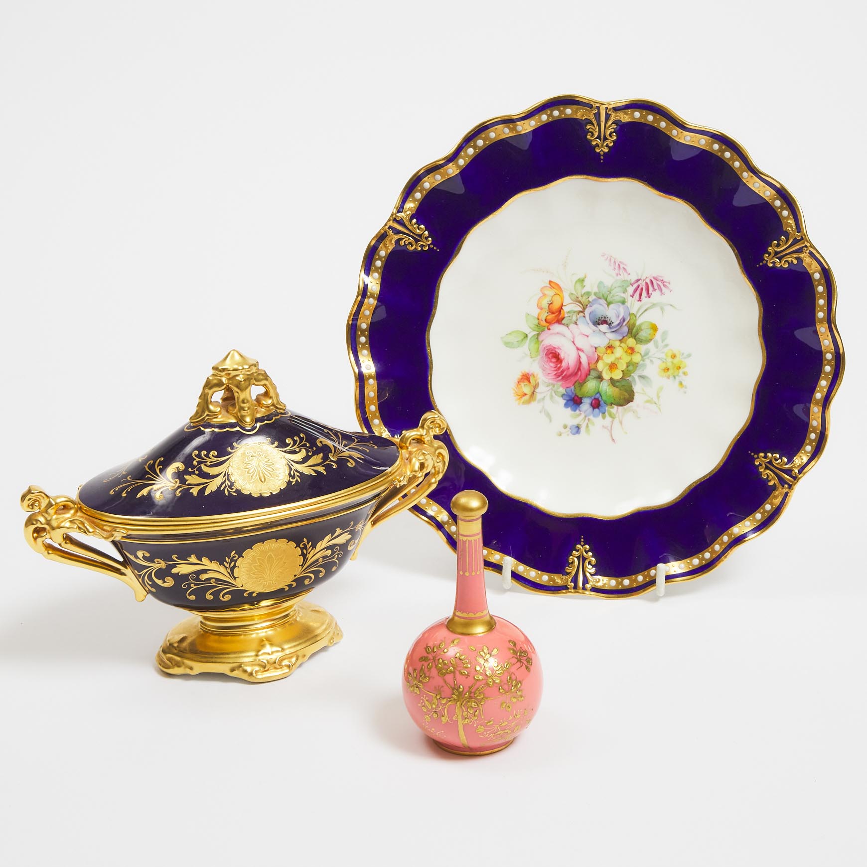 Royal Crown Derby Pink Ground Bottle with Stopper, Flower Painted Plate and a Blue and Gilt Covered Two-Handled Vase, c.1896/1933 and later