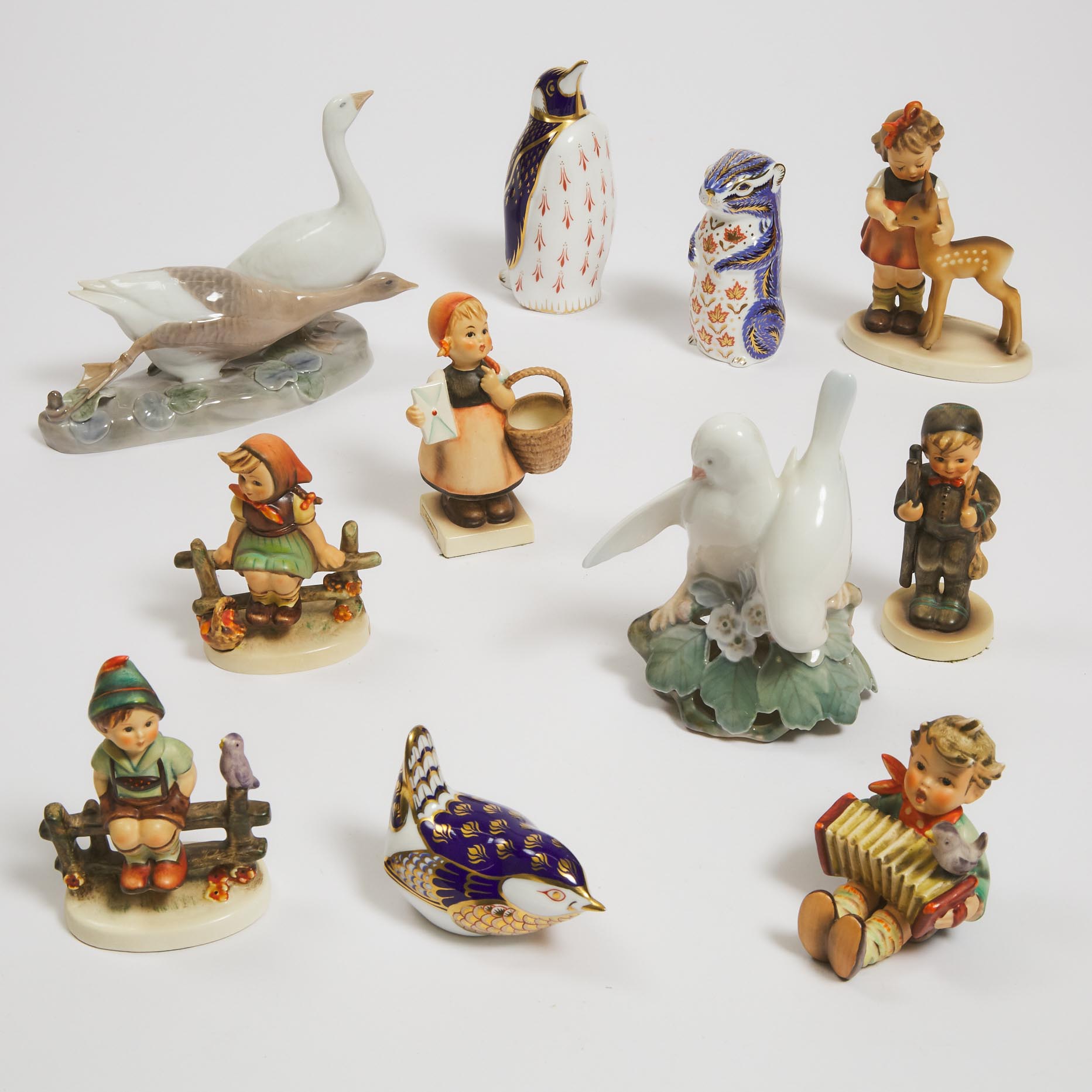 Two Royal Copenhagen Bird Groups, Royal Crown Derby Penguin, Sparrow and a Squirrel, and Six Hummel Figures of Children, 20th century