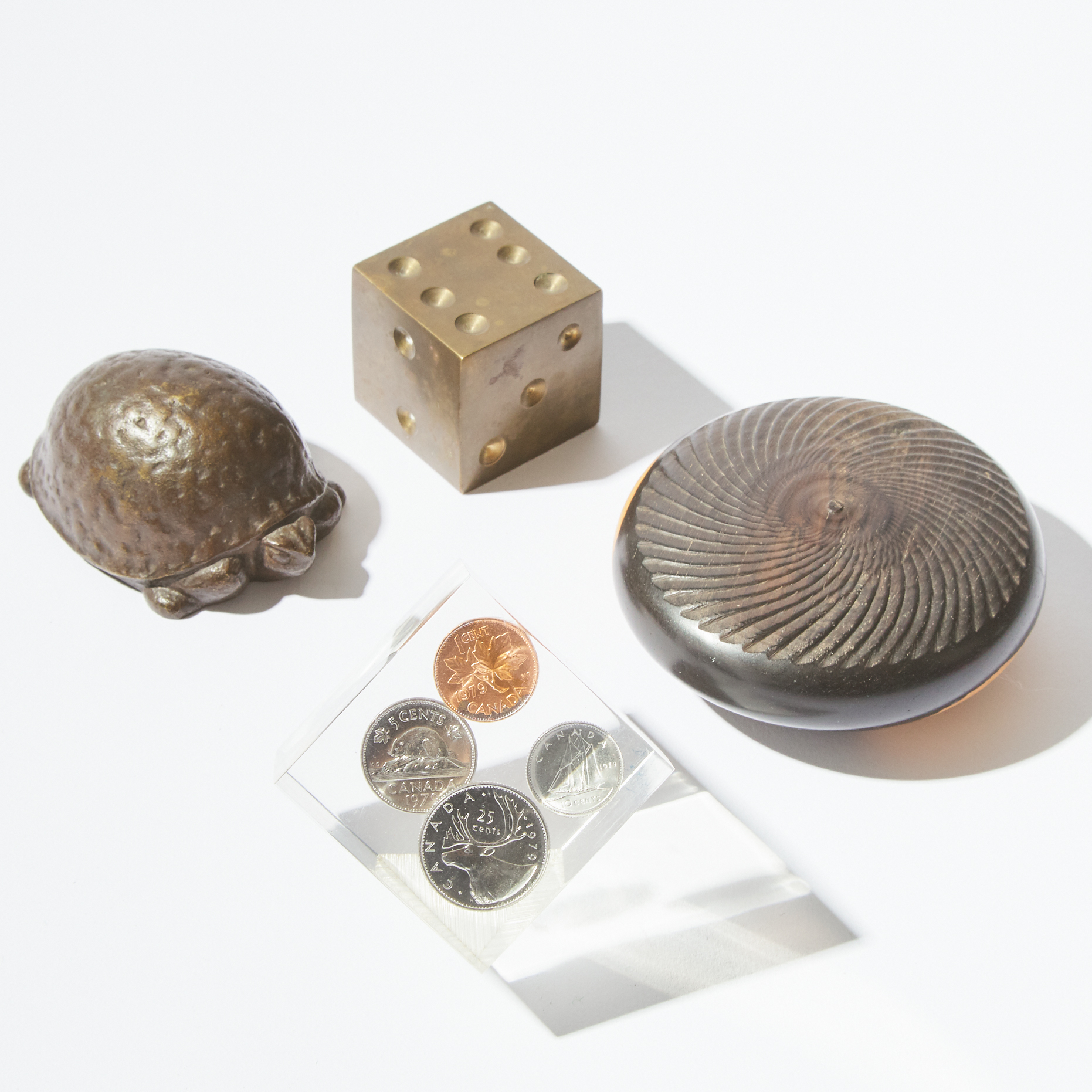 Four Various Bronze, Wood and Lucite Paperweights, 20th century