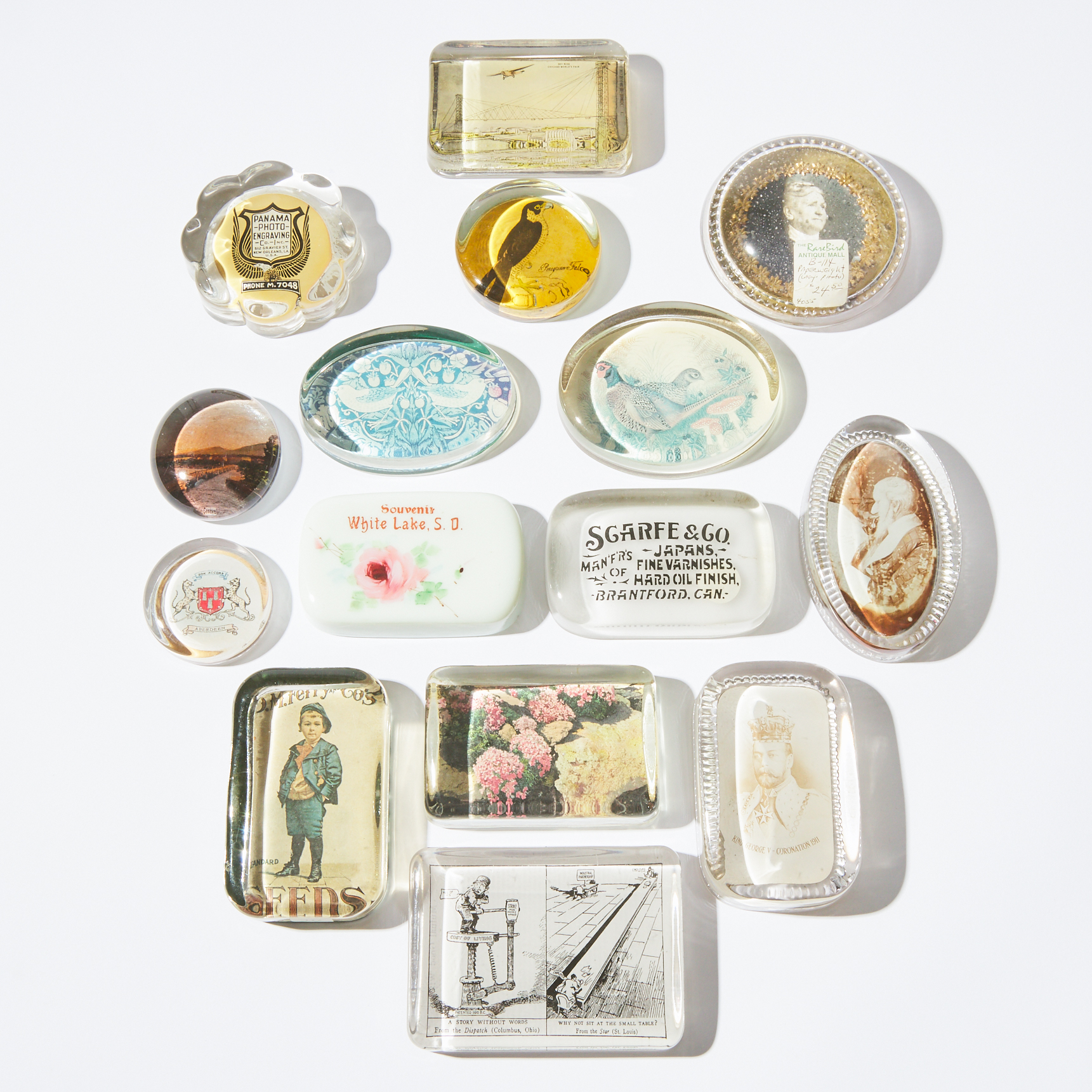 Collection of Fifteen North American and British Commemorative, Advertising, and other Lithographic Glass Paperweights, late 19th/20th century