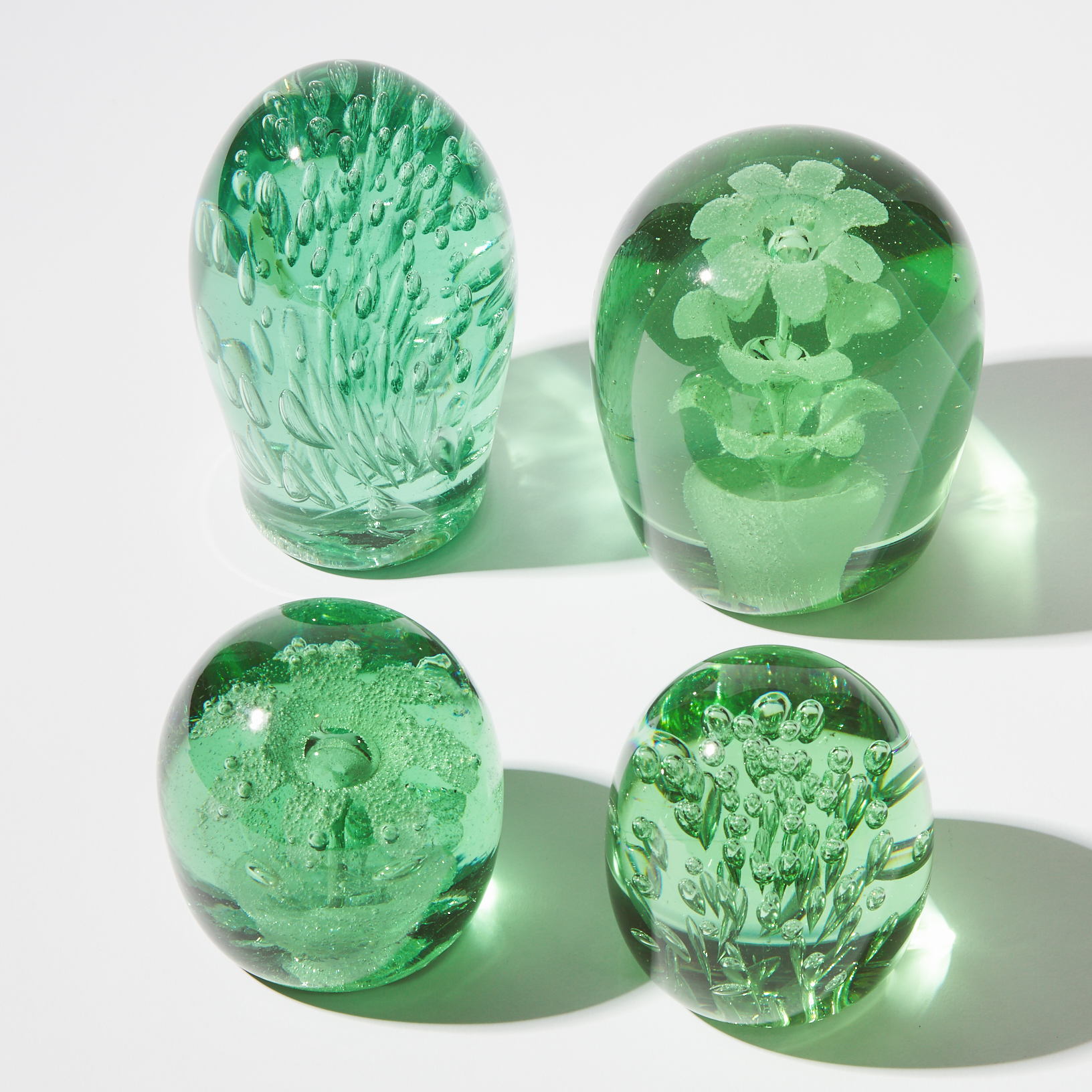 Four Green Bottle Glass Dump Paperweights, possibly Nailsea, 19th century