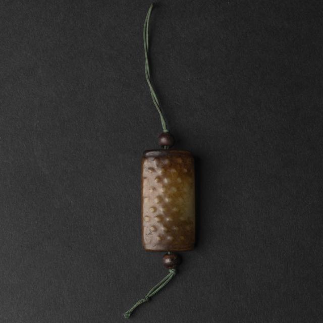 A Celadon and Russet 'Chilong' Tubular Pendant, Ming Dynasty (1368-1644)