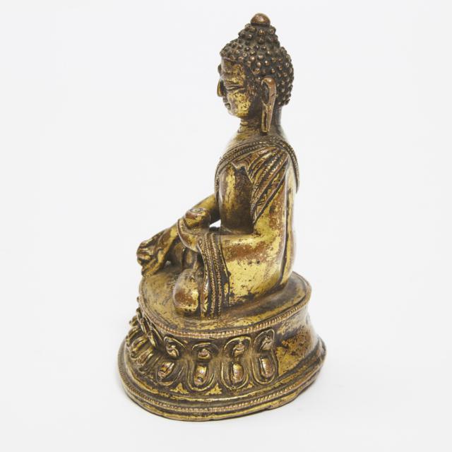 A Gilt Copper Alloy Figure of Medicine Buddha, Nepal, 14th Century