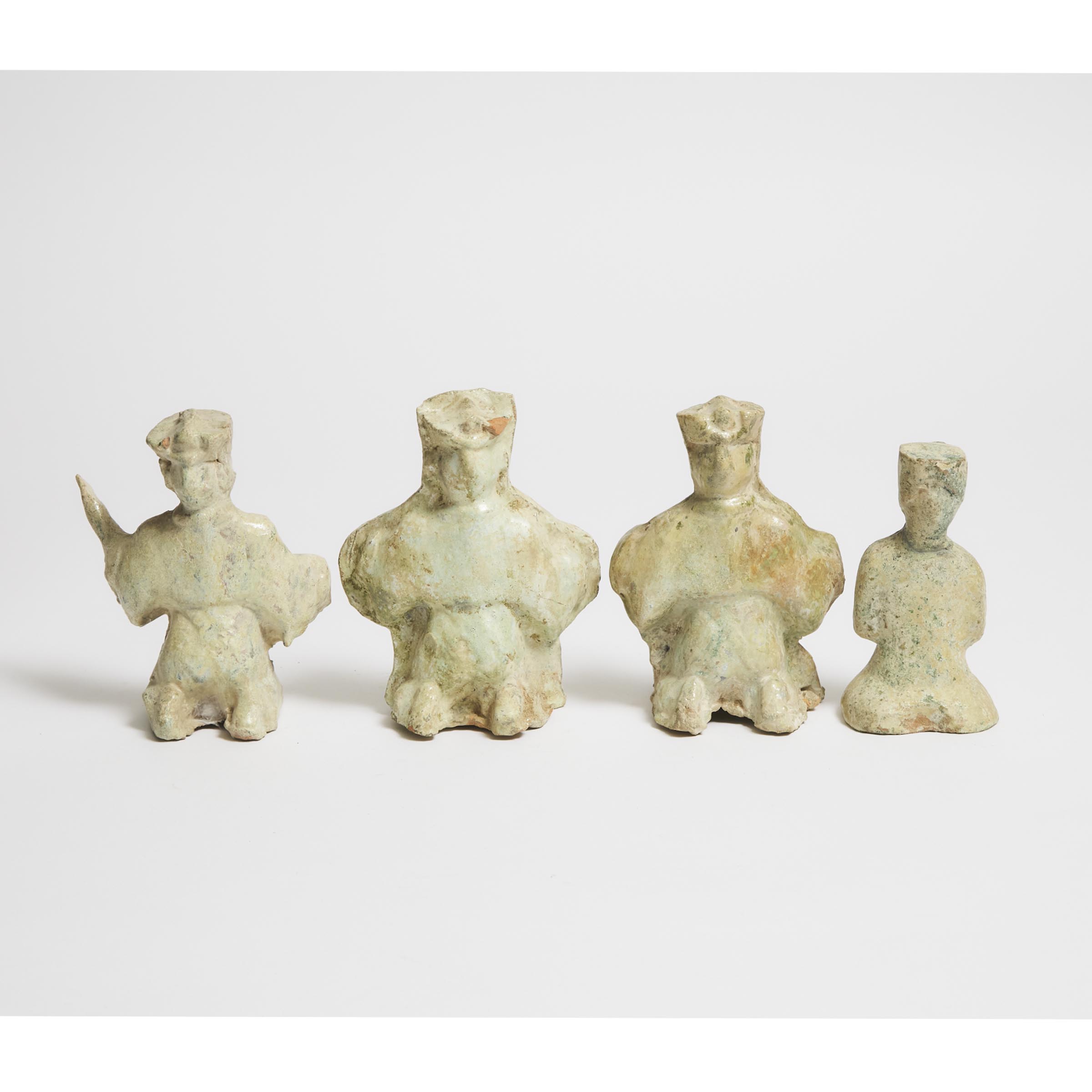 A Group of Four Green-Glazed Pottery Seated Figures, Han Dynasty (206 BC-AD 220)