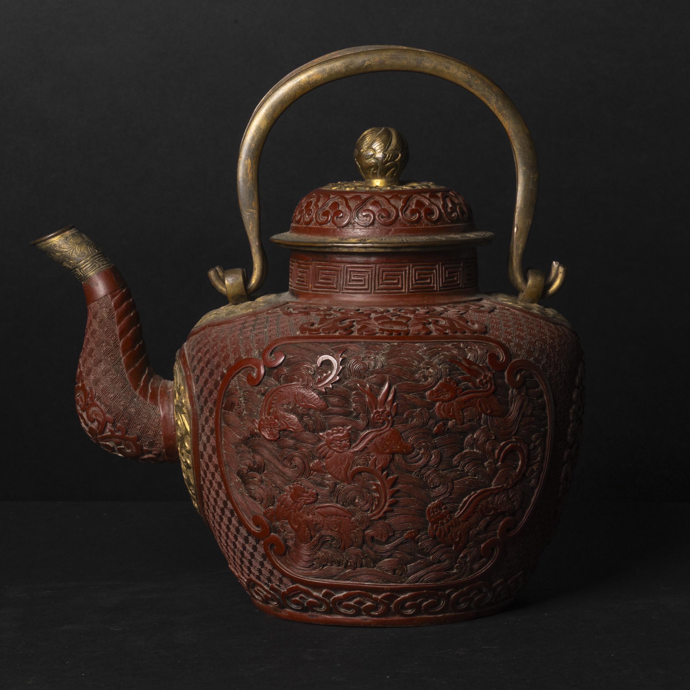 A Red Lacquer 'Twin-Lion' Teapot with Gilt Copper Fittings, 19th Century