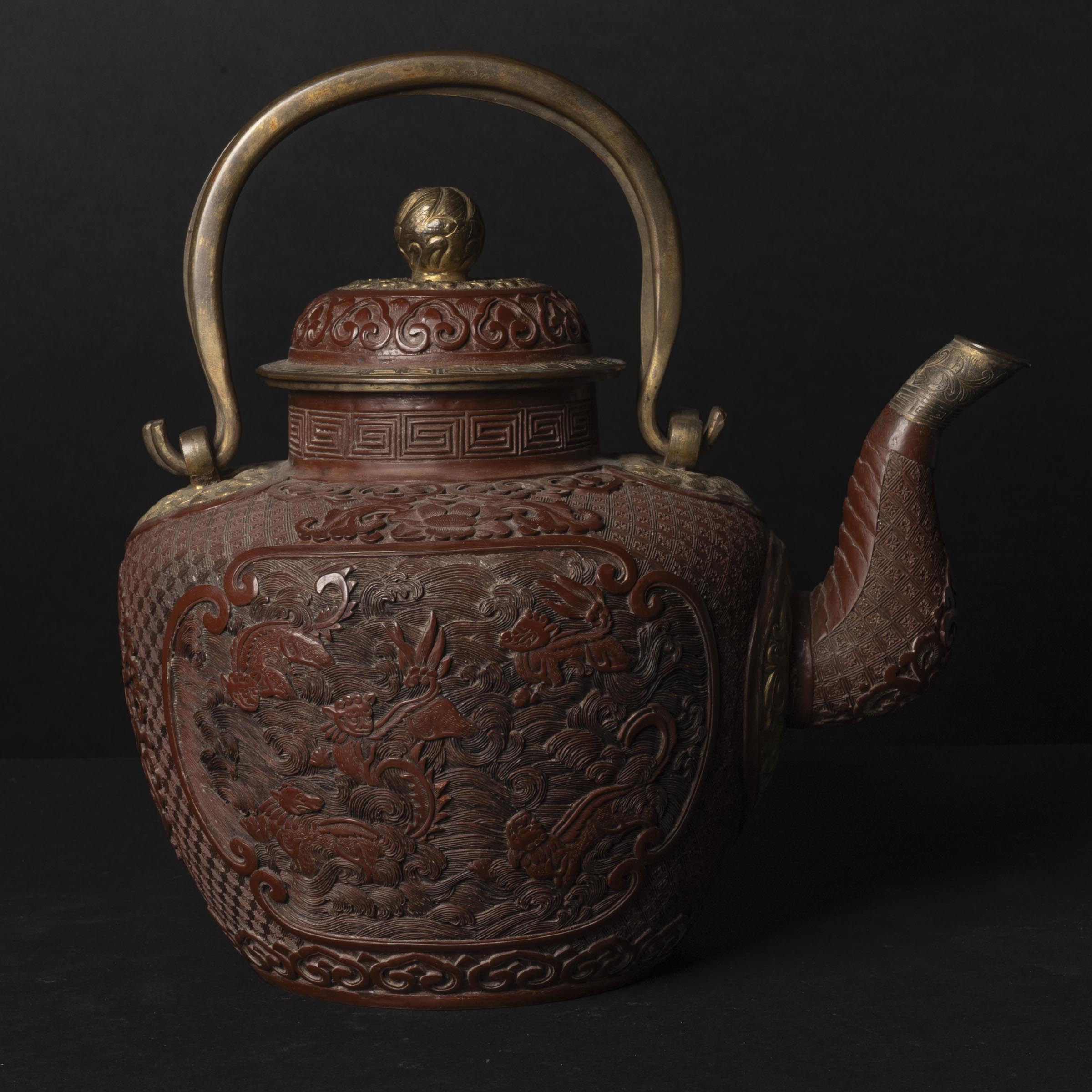 A Red Lacquer 'Twin-Lion' Teapot with Gilt Copper Fittings, 19th Century