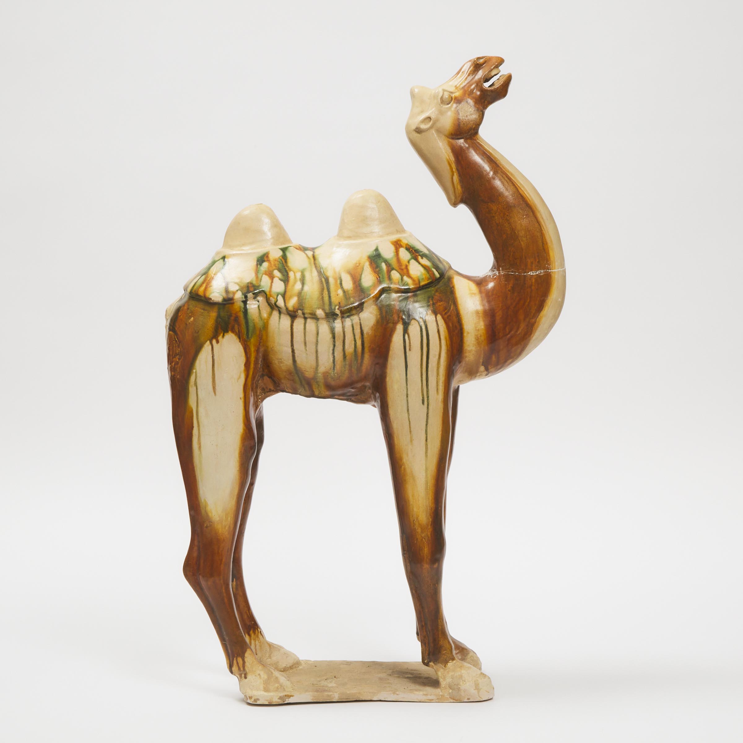 A Large Sancai-Glazed Pottery Figure of a Bactrian Camel, Tang Dynasty (AD 618-907)