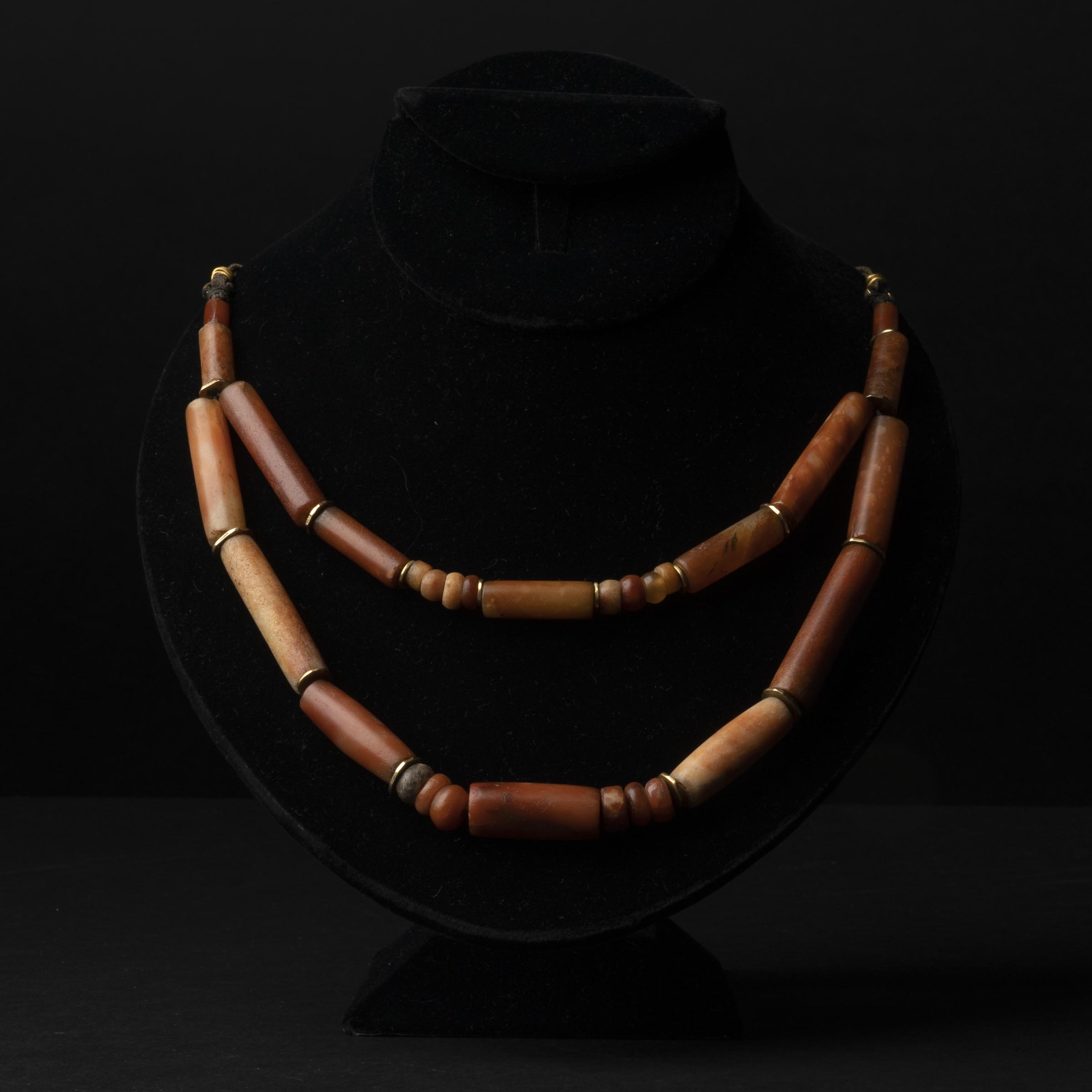 A Strand of Ancient Agate and Carnelian Tubular and Beaded Necklace, with Yellow Gold Spacers, Circa 400-800 BC