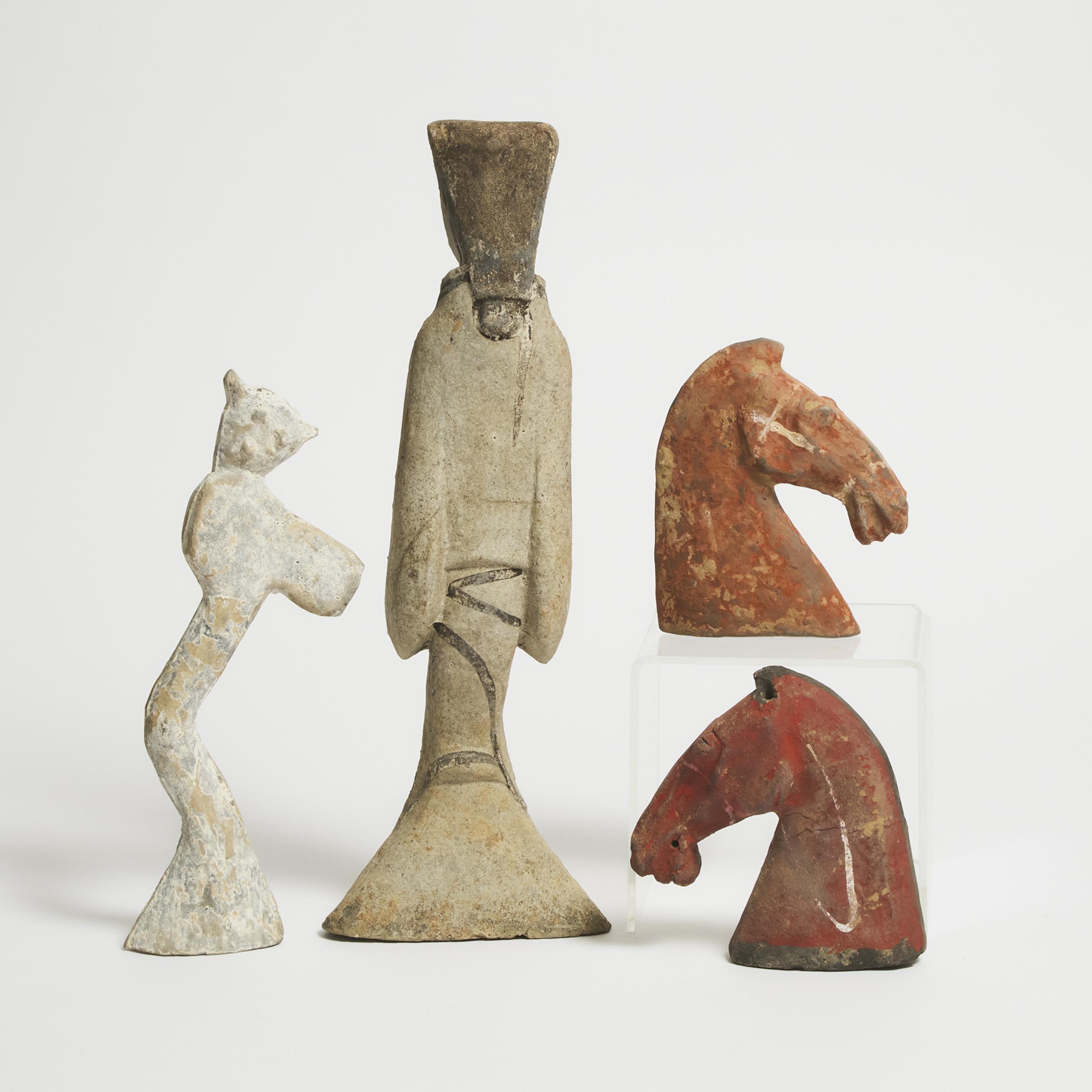 A Group of Four Pottery Figures and Horse Heads, Han Dynasty (206 BC-AD 220)