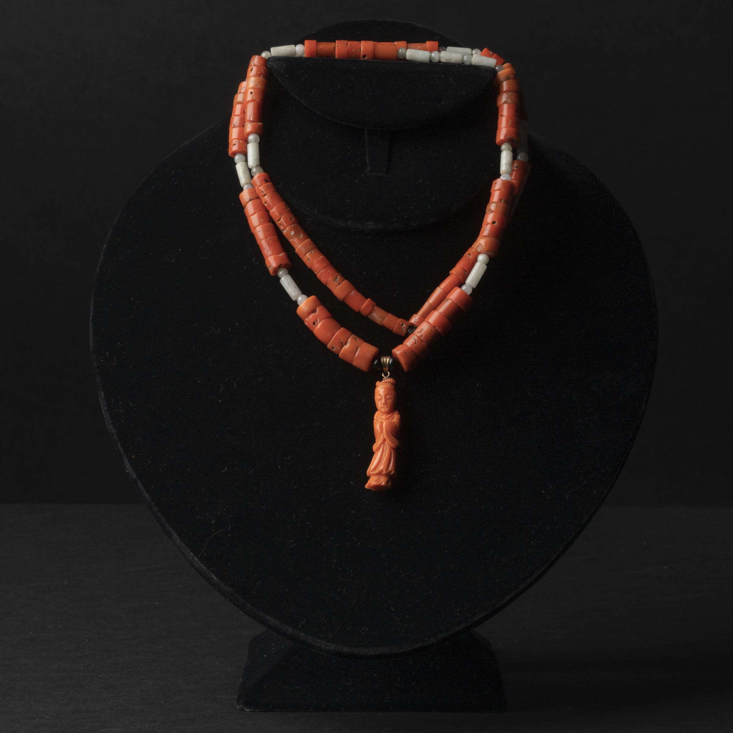 A Carved Coral Necklace With a Carved Coral 'Beauty' Figural Pendant, 19th Century