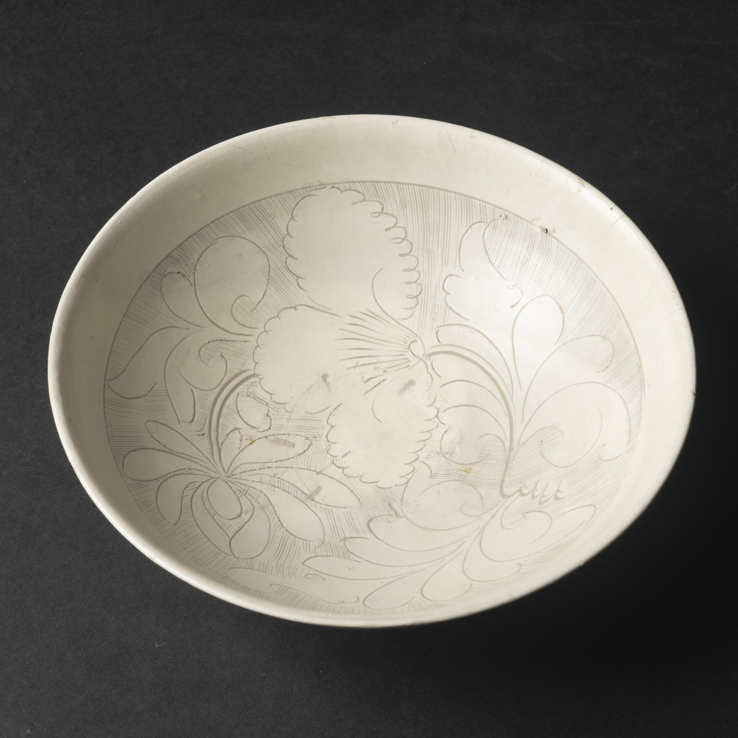 A Cizhou-Type White-Glazed Carved 'Floral' Bowl, Jin/Yuan Dynasty, 12th-14th Century