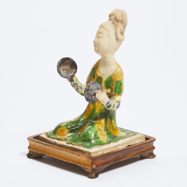 A Sancai-Glazed Pottery Figure of a Seated Female Court Musician, Tang Dynasty (618-907)