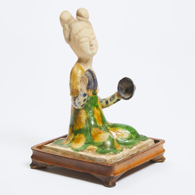 A Sancai-Glazed Pottery Figure of a Seated Female Court Musician, Tang Dynasty (618-907)