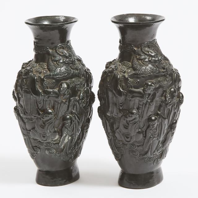 A Pair of Moulded Ceramic 'Eighteen Luohan' Vases, Qianlong Mark, 20th Century