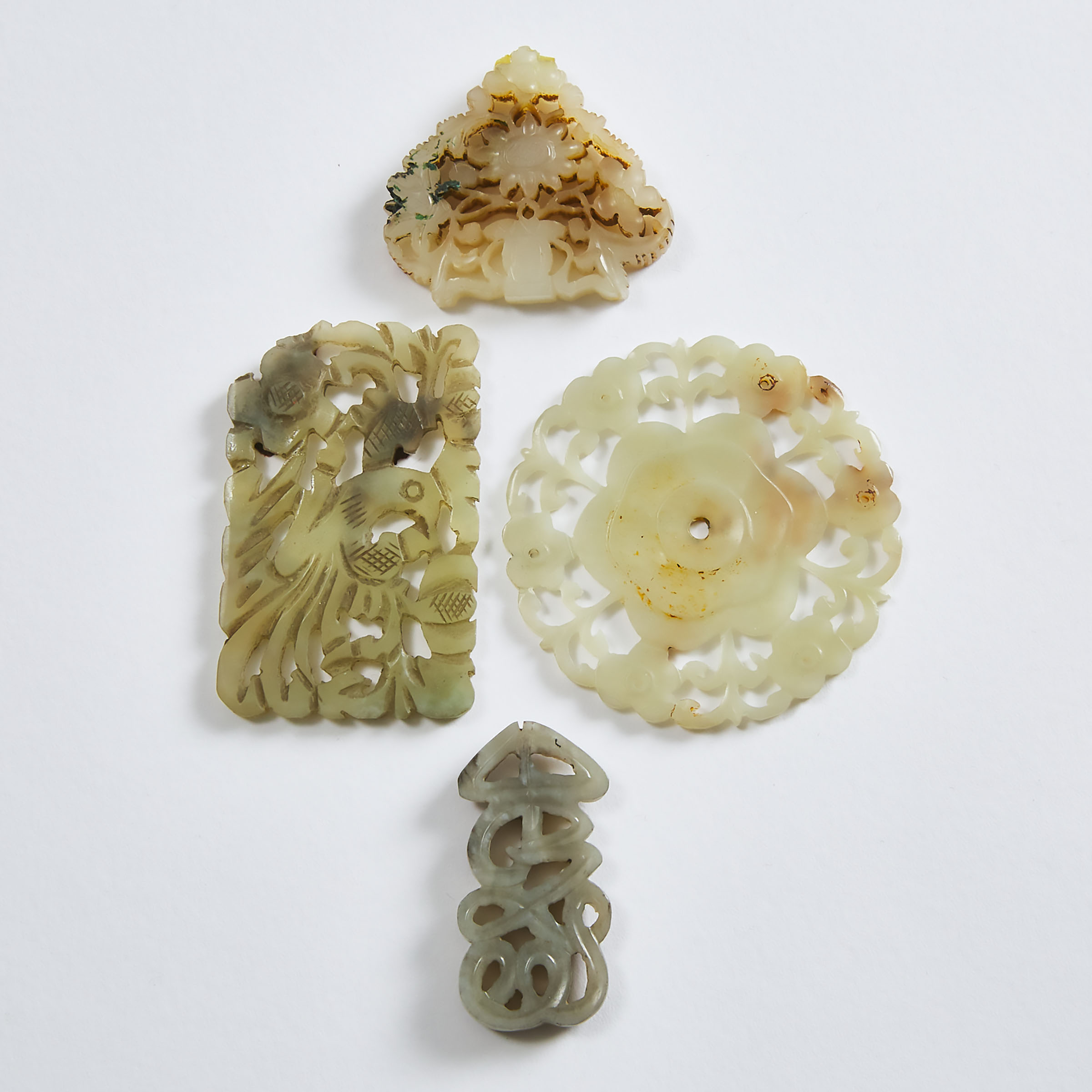 A Group of Four Carved White Jade Plaques, Qing Dynasty and Earlier