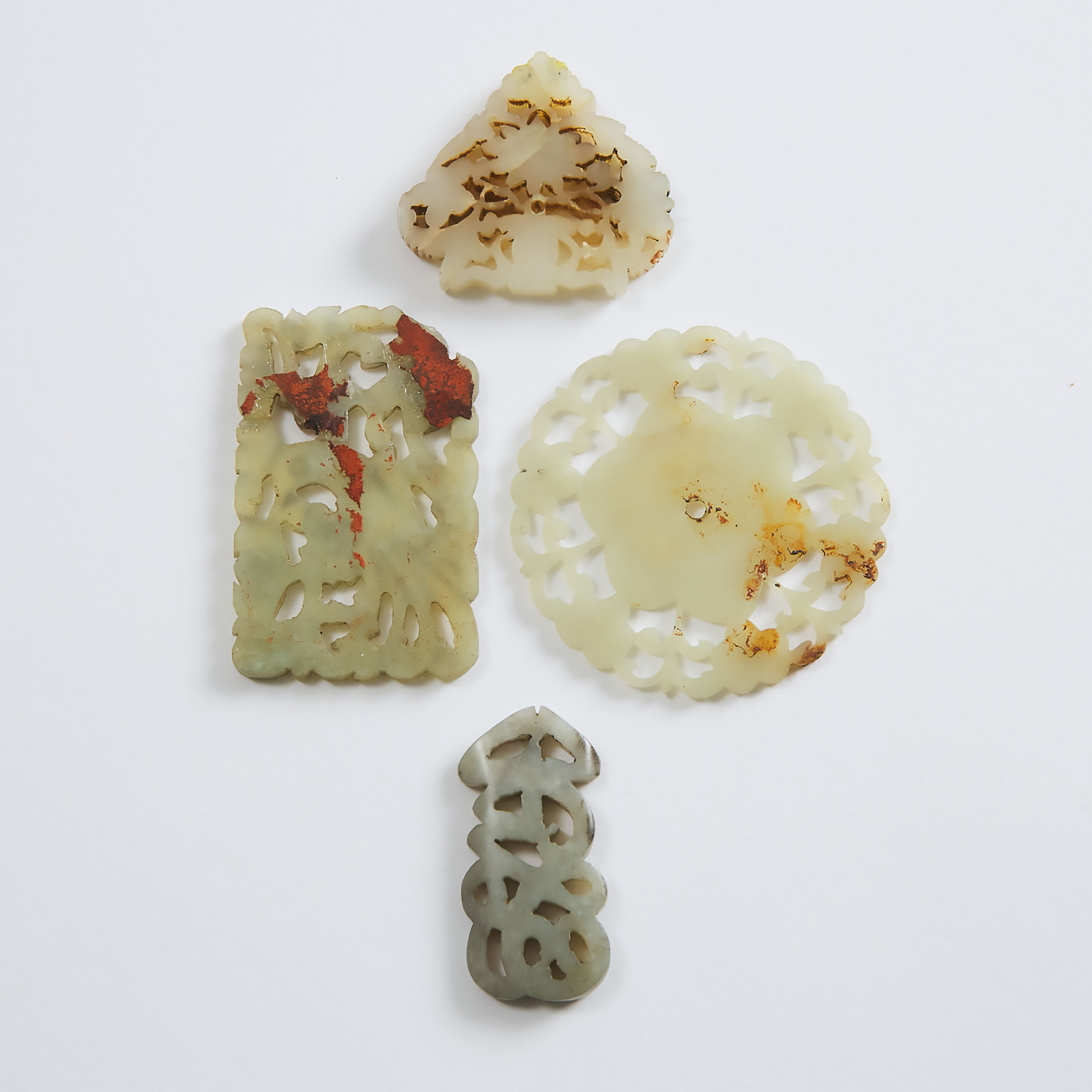 A Group of Four Carved White Jade Plaques, Qing Dynasty and Earlier